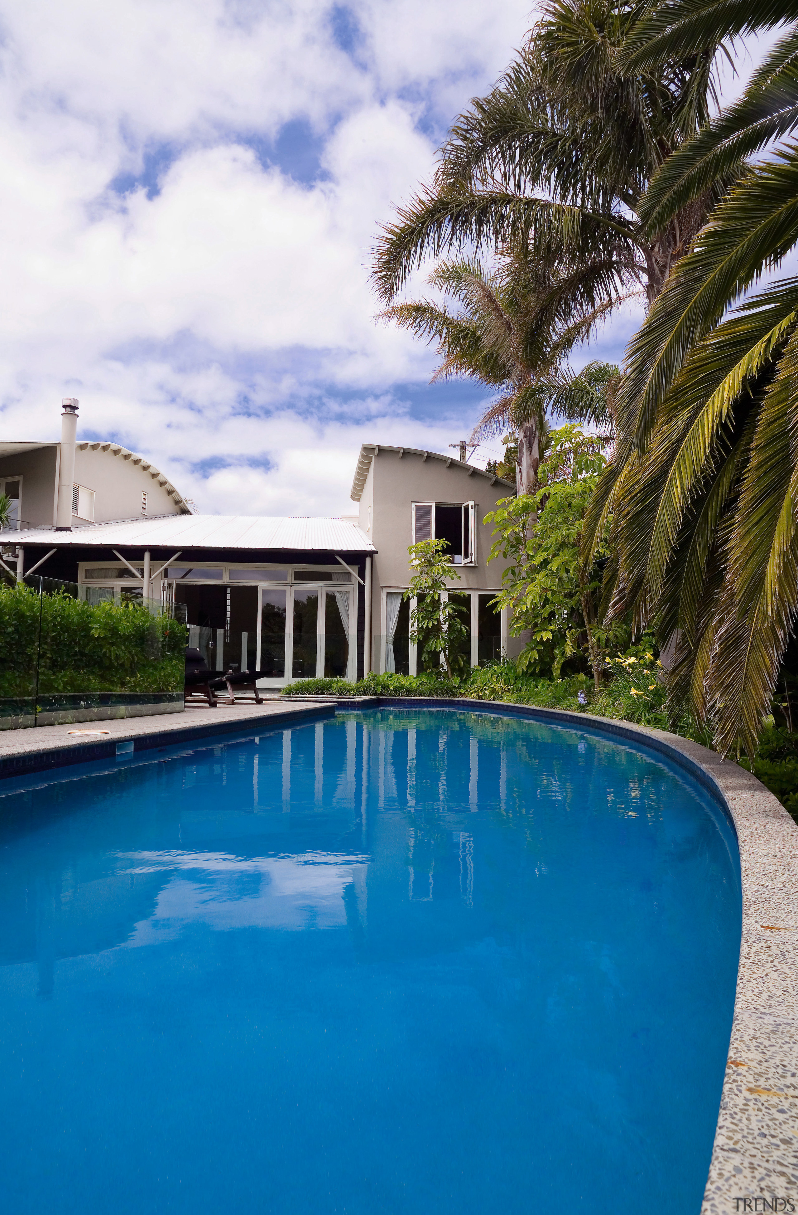 The owners of this 1990s home wanted a arecales, estate, hacienda, home, house, leisure, mansion, palm tree, property, real estate, reflection, resort, sky, swimming pool, tree, tropics, vacation, villa, water, blue