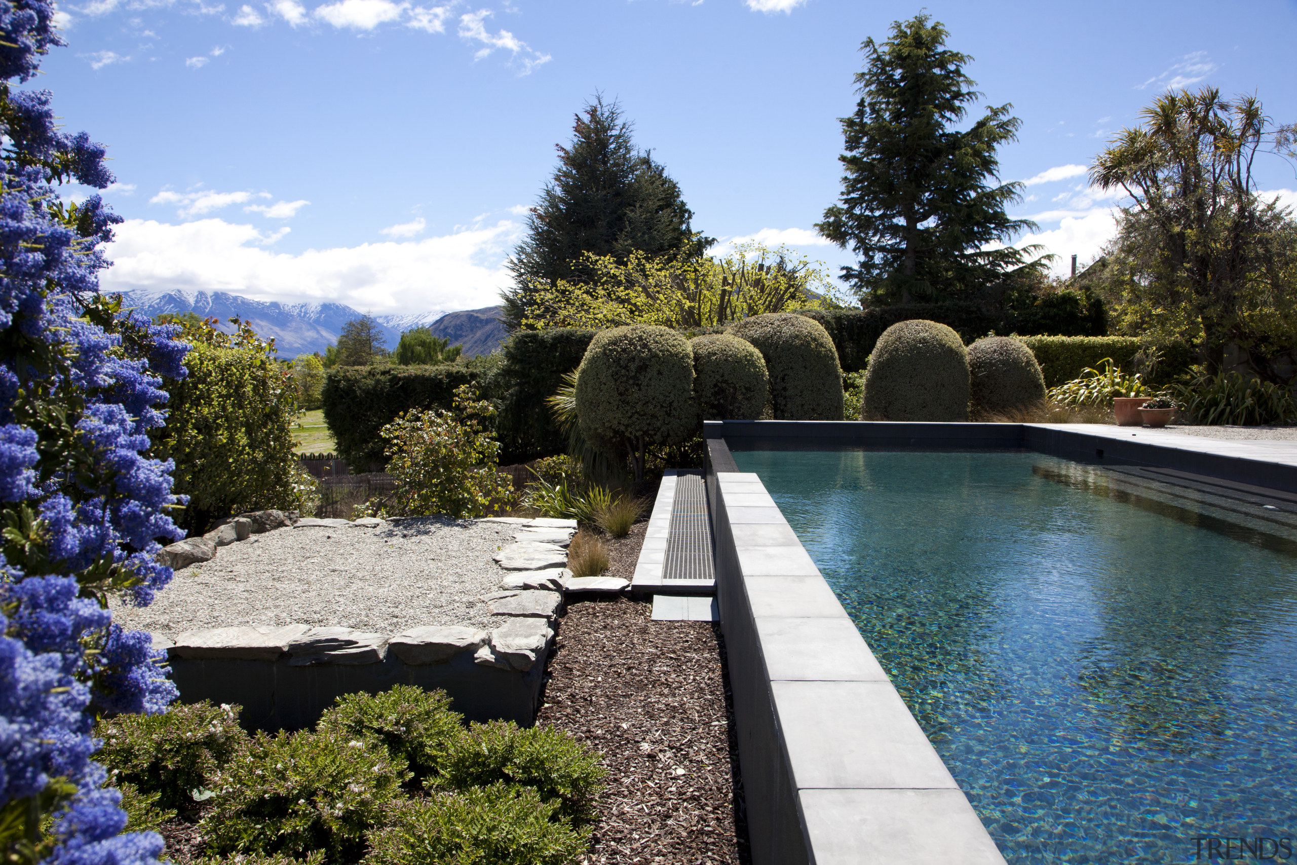 View of pool and landscaping. - View of backyard, estate, garden, home, landscape, landscaping, leisure, outdoor structure, plant, property, real estate, swimming pool, tree, villa, water, water feature, yard, teal