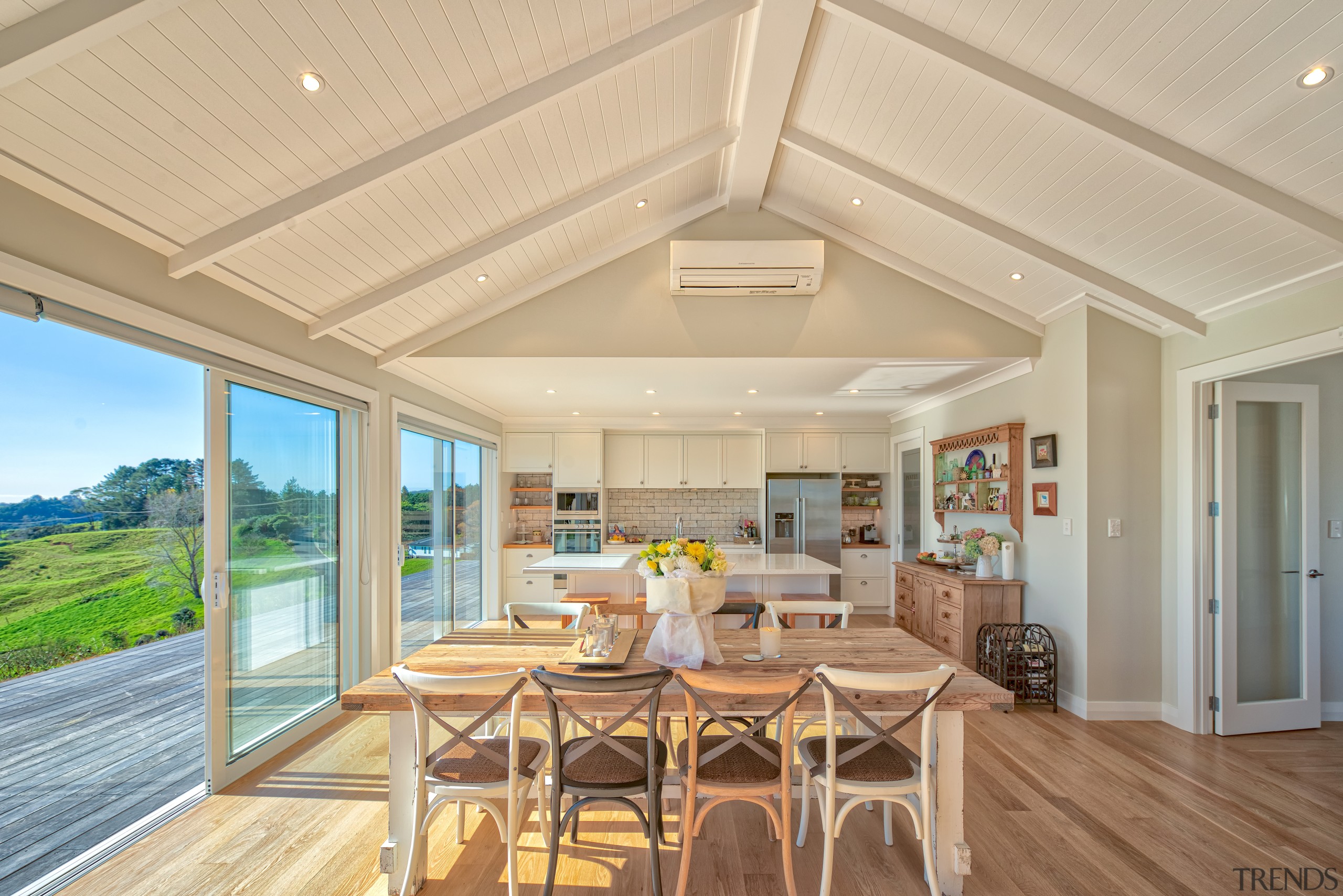 A soaring 2.7m tongue-and-groove ceiling sets off this timber ceiling, hardwood, home, house, interior design, living room, real estate, window, wood flooring, orange, open plan living,  fowler homes