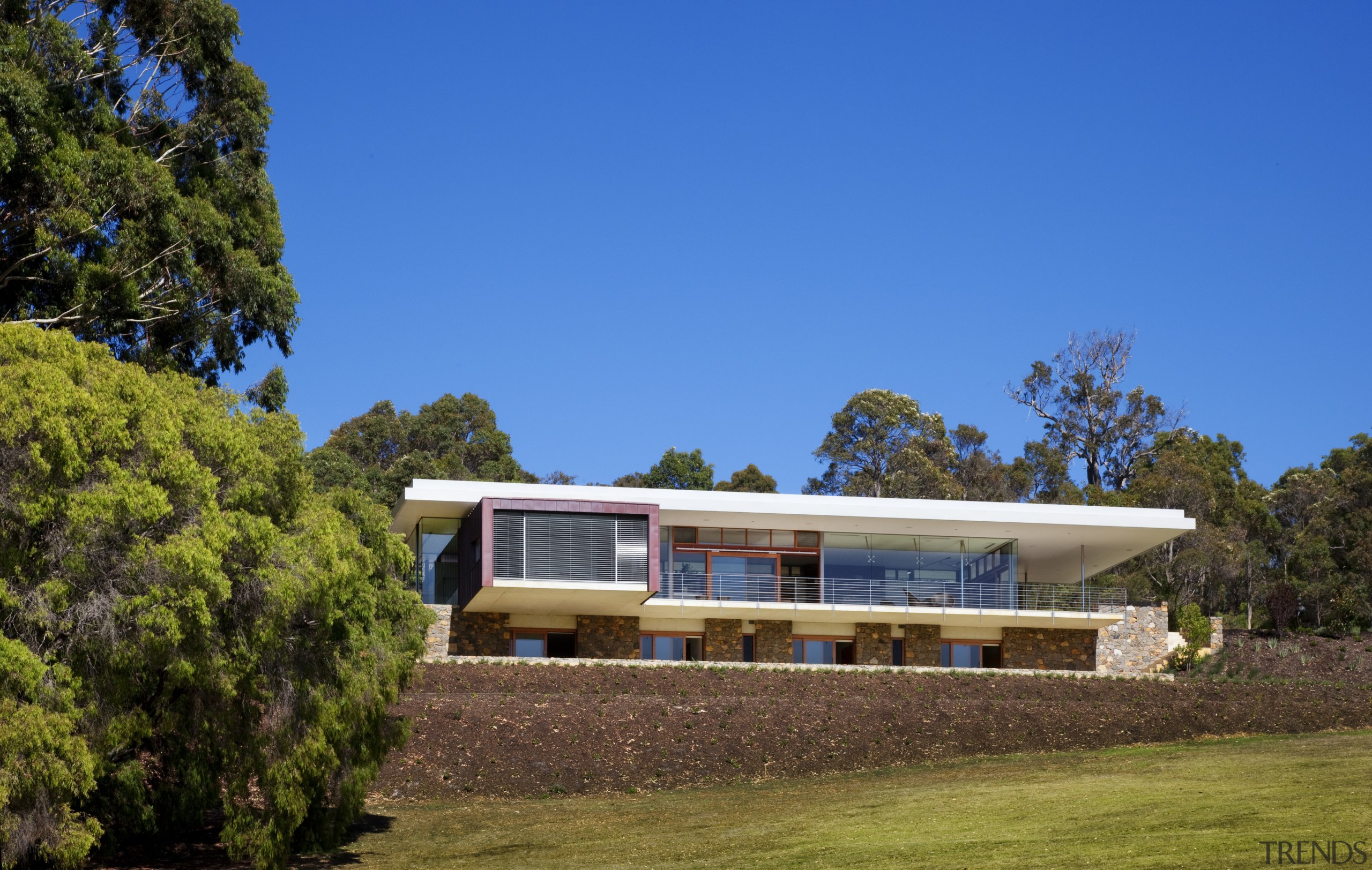 This house was designed by Tim Wright AIA architecture, cottage, estate, facade, farmhouse, home, house, landscape, property, real estate, sky, tree, villa, brown, blue