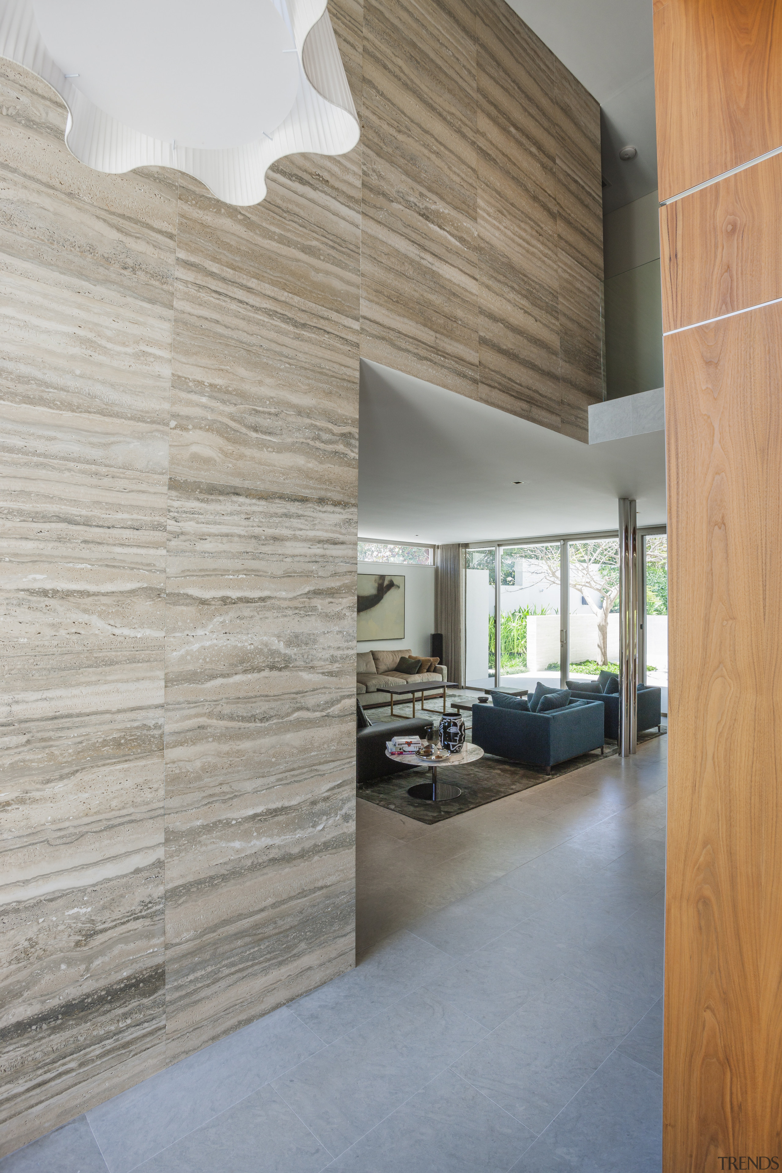 The feature stone extends through to the interior, architecture, ceiling, daylighting, floor, flooring, home, house, interior design, wall, wood, wood flooring, gray