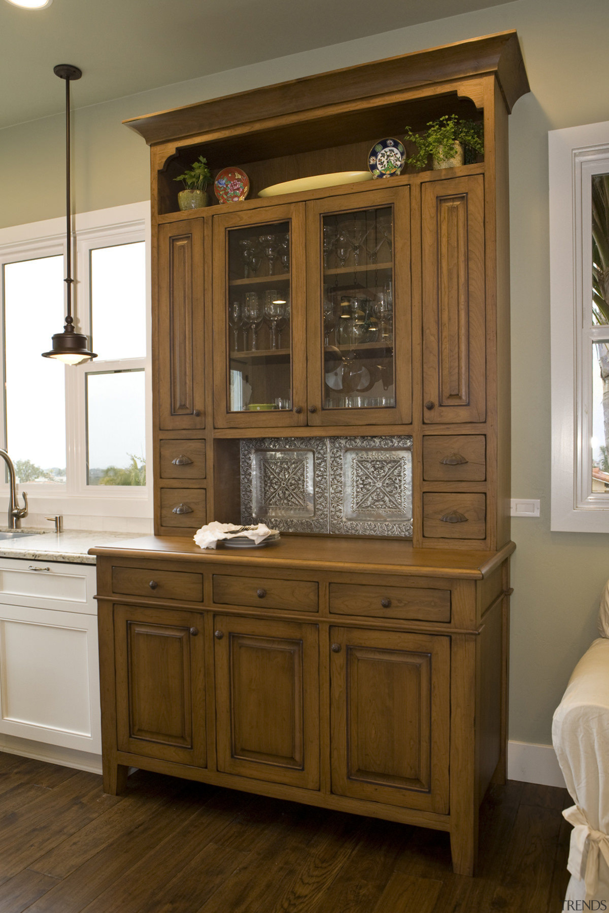 View of kitchen with wooden flooring and cabinetry, cabinetry, chest of drawers, countertop, cuisine classique, cupboard, drawer, furniture, hardwood, interior design, kitchen, room, wood stain, brown