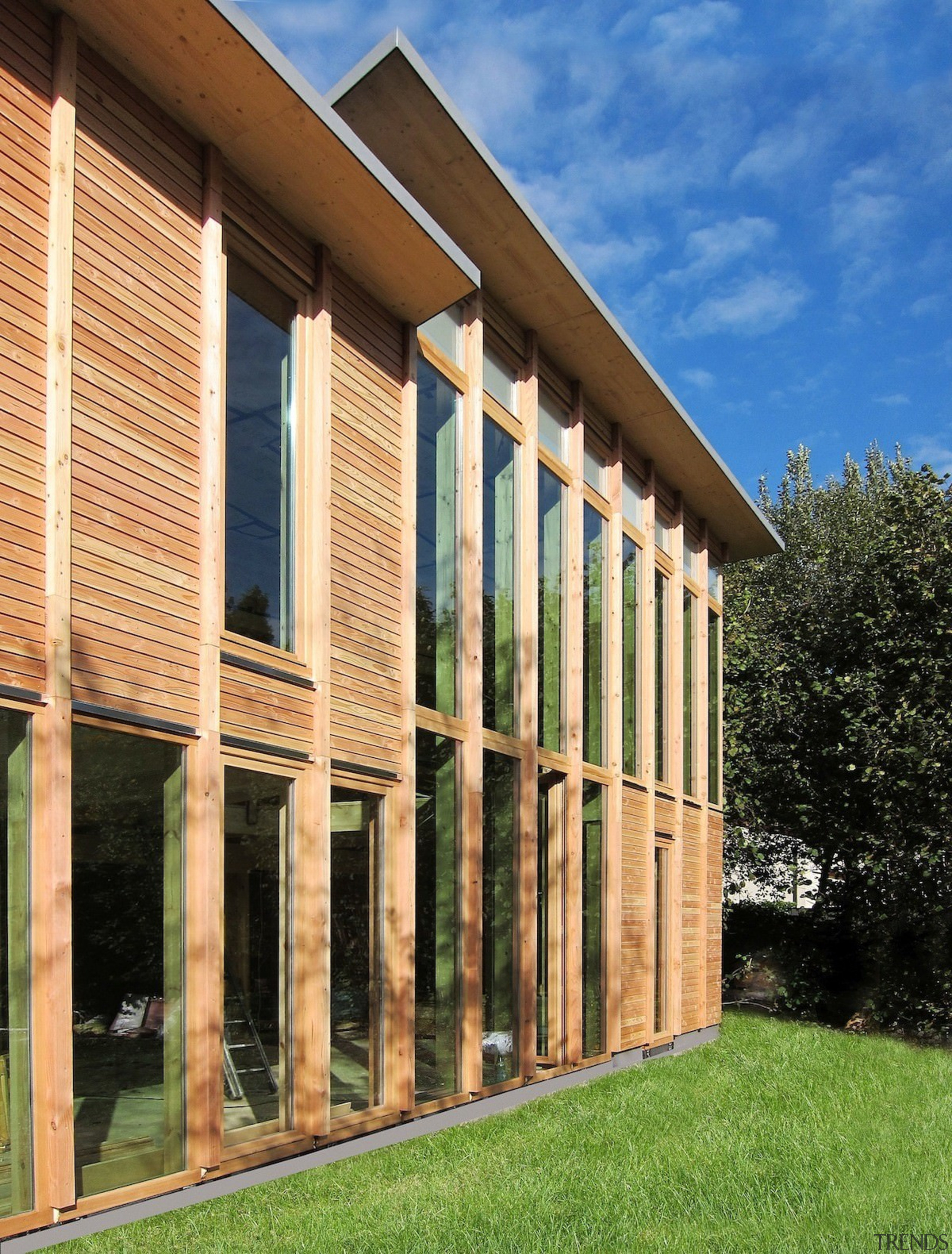 A closer view of the wood exterior - architecture, column, facade, grass, house, real estate, siding, structure, window, orange