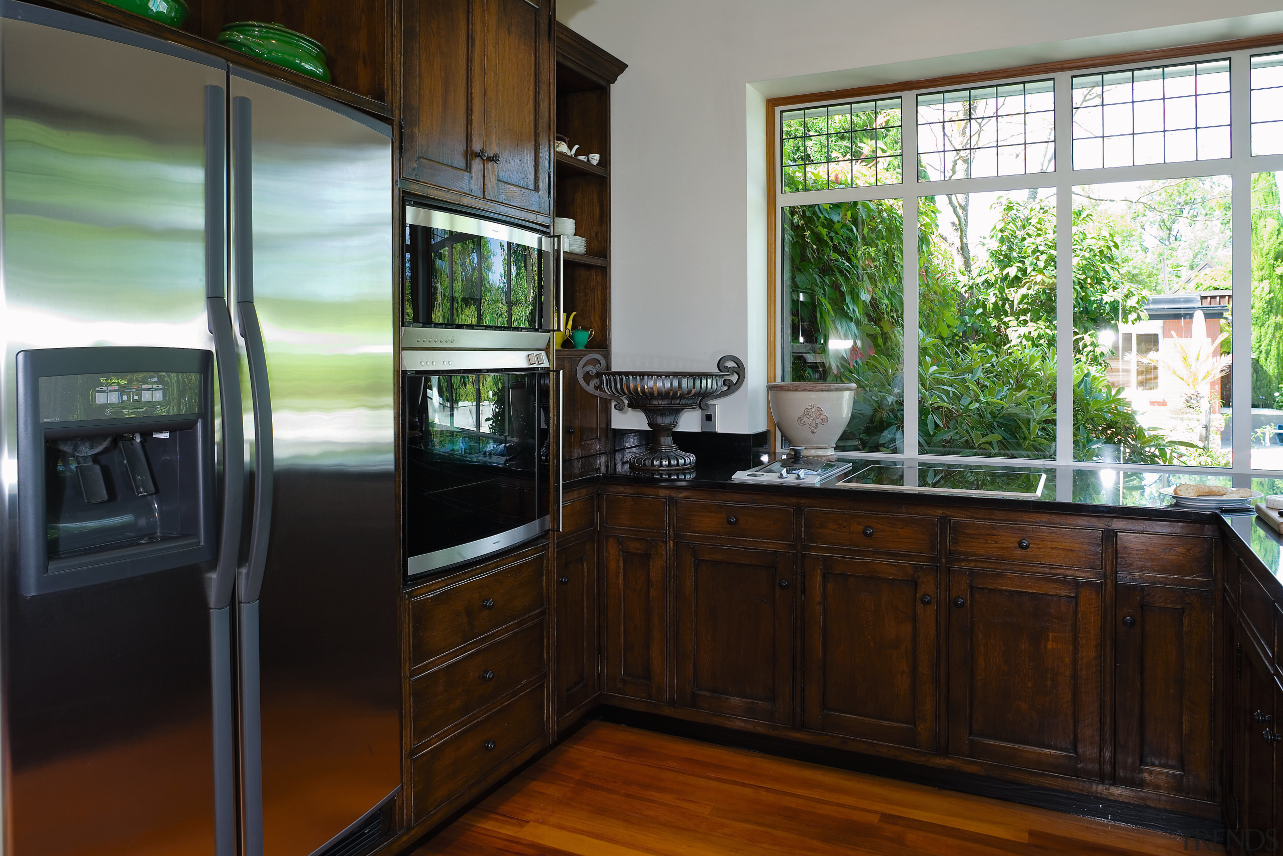 A view of this kitchen feautring solida aged countertop, home, house, kitchen, real estate, room, window, wood, black