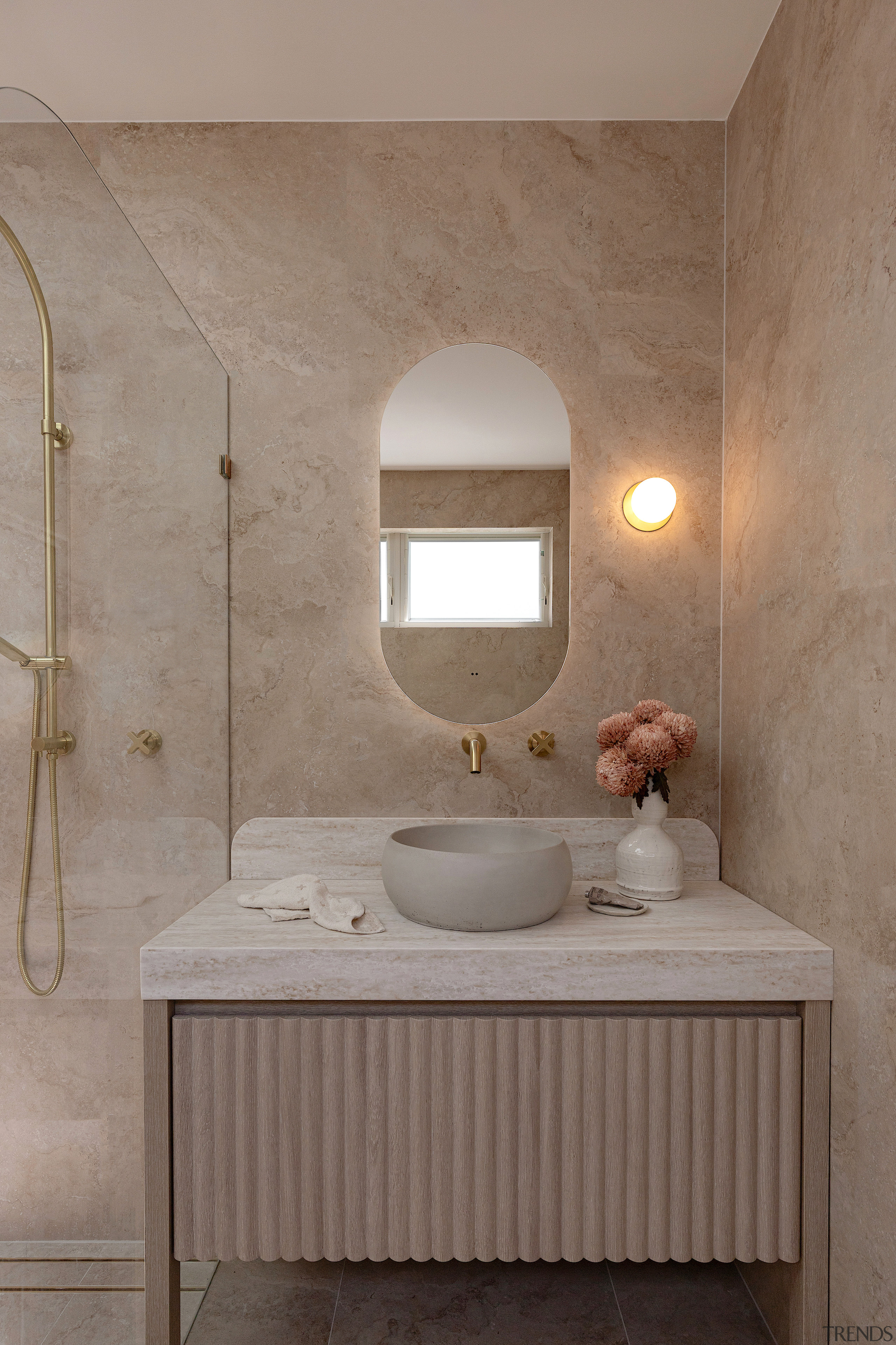 An oval mirror follows the soft lines of 