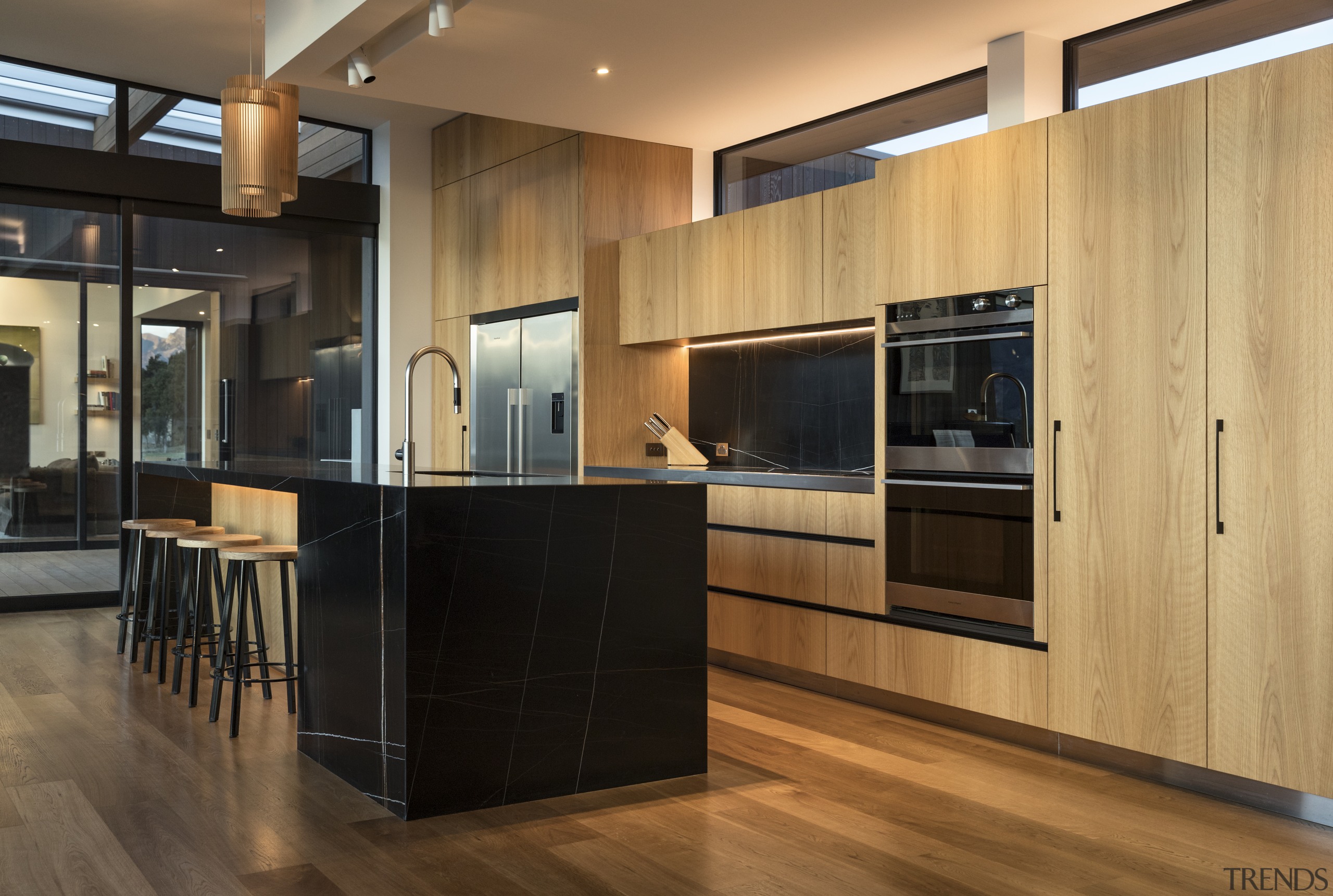 ​​​​​​​Recessed track spots above this benchtop provide a architecture, kitchen, cabinetry, countertop, cupboard, timber flooring, home, house, interior design, kitchen, wood flooring, wood stain, brown, black, lighting, feature lighting, fisher & Paykel, Eliska Lewis Architects