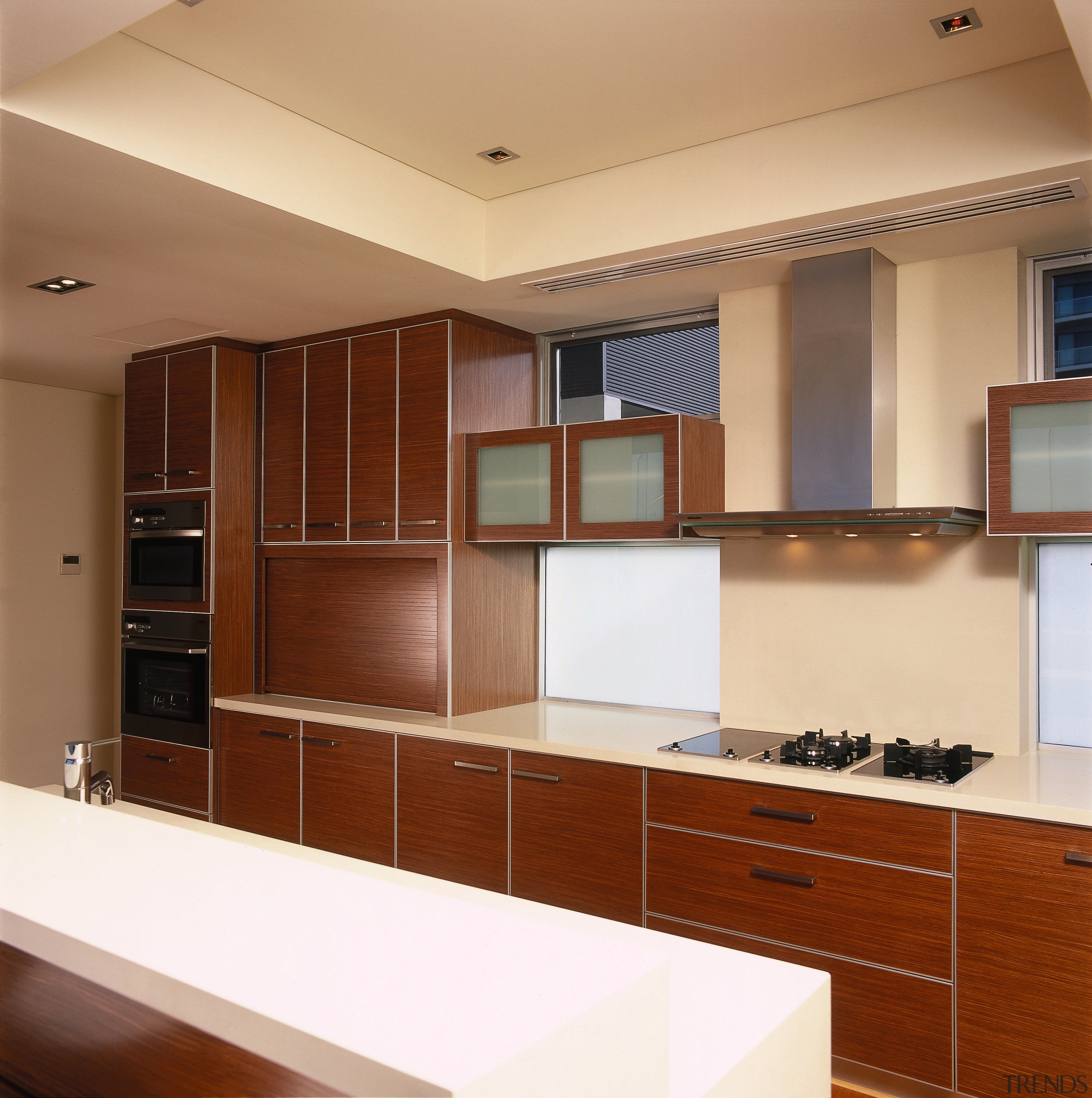 view of this apartment kitchen featuring miele kitchen cabinetry, countertop, cuisine classique, interior design, kitchen, room, brown