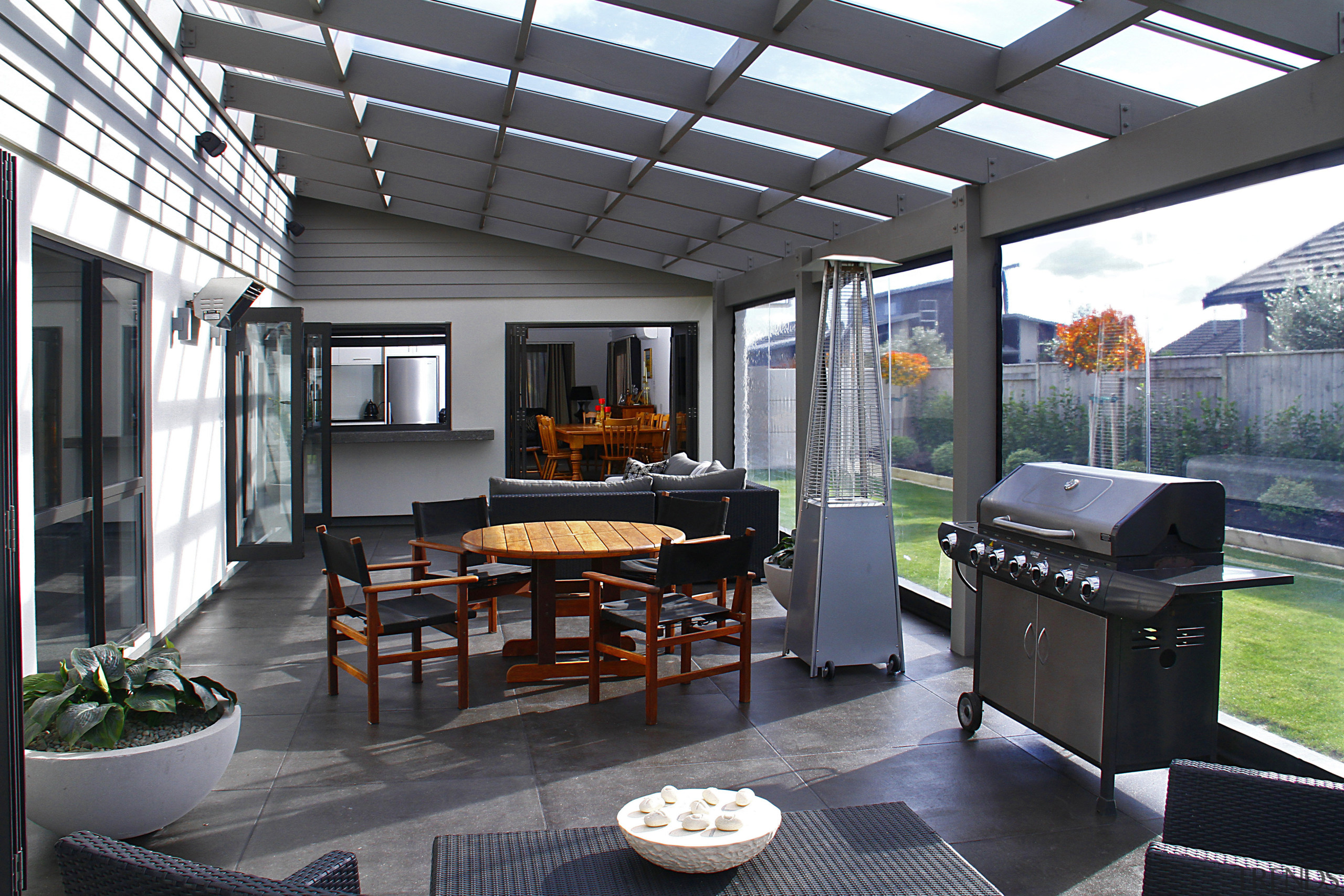 An all-weather outdoor space is the social hub interior design, outdoor structure, patio, real estate, gray, black