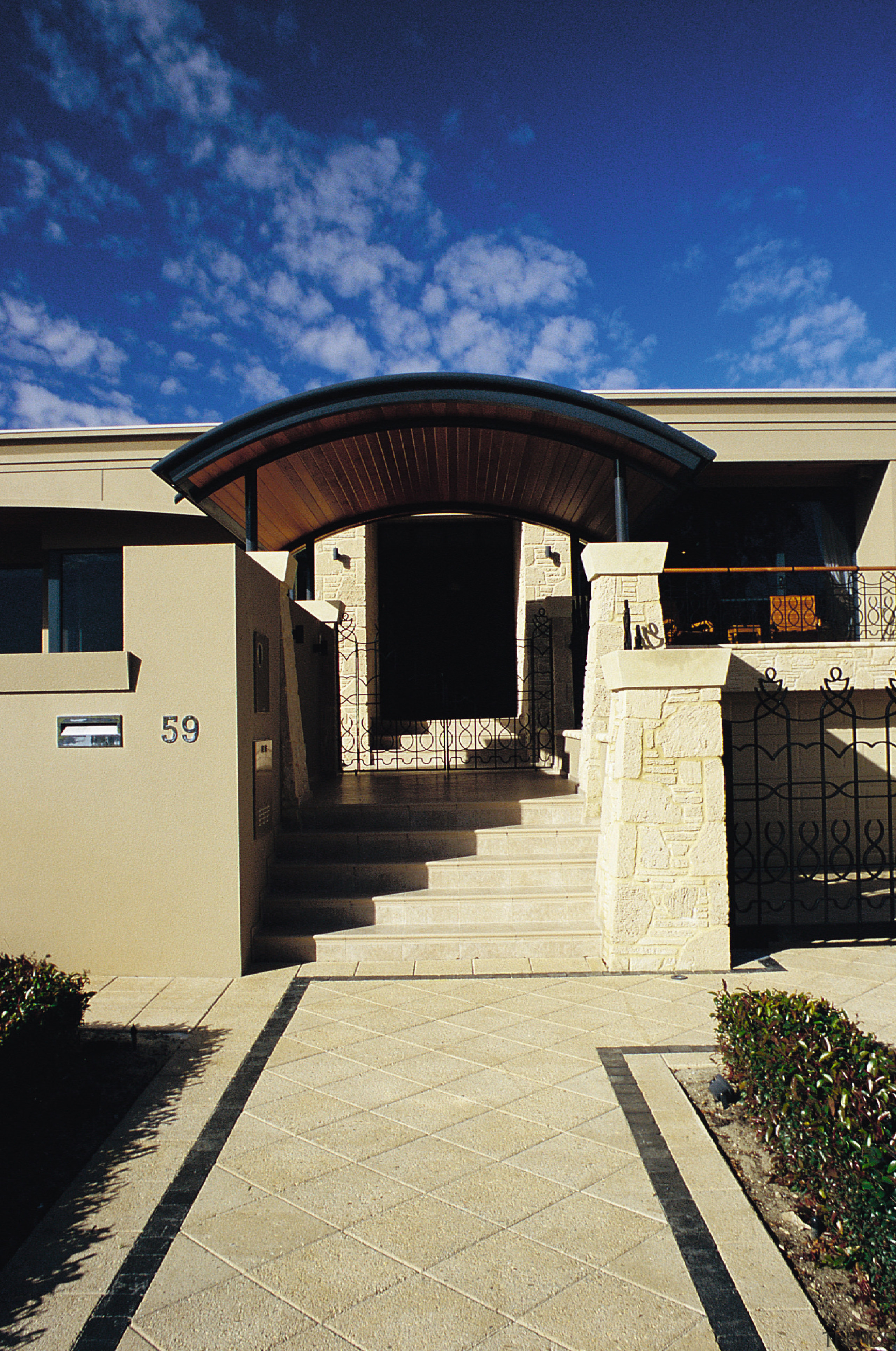 Entranceway to home with stairs and arched roof, architecture, building, estate, facade, home, house, property, real estate, residential area, roof, sky, structure, blue, orange