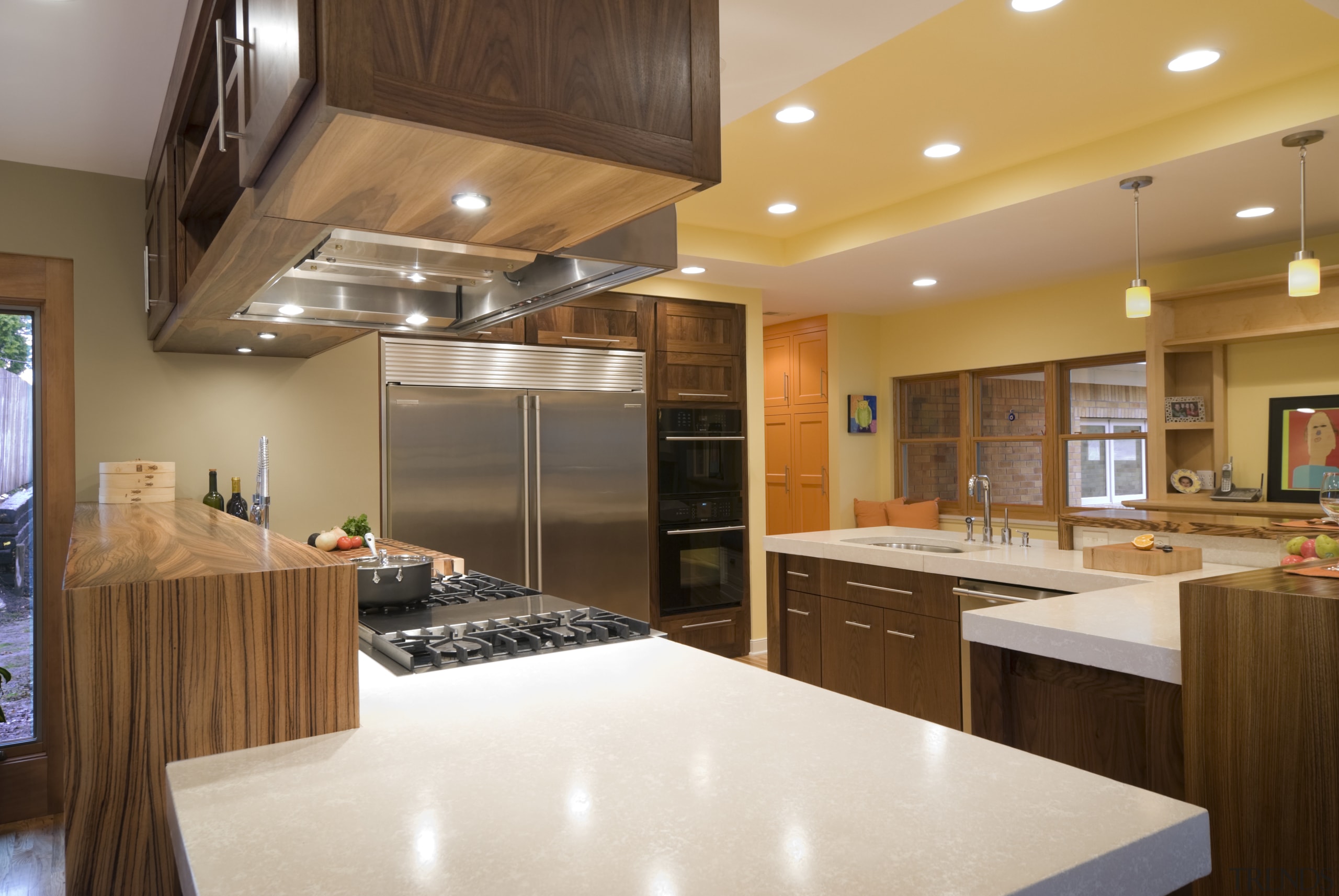 View of a kitchen which features a L-shaped cabinetry, ceiling, countertop, cuisine classique, interior design, kitchen, real estate, room, brown, orange