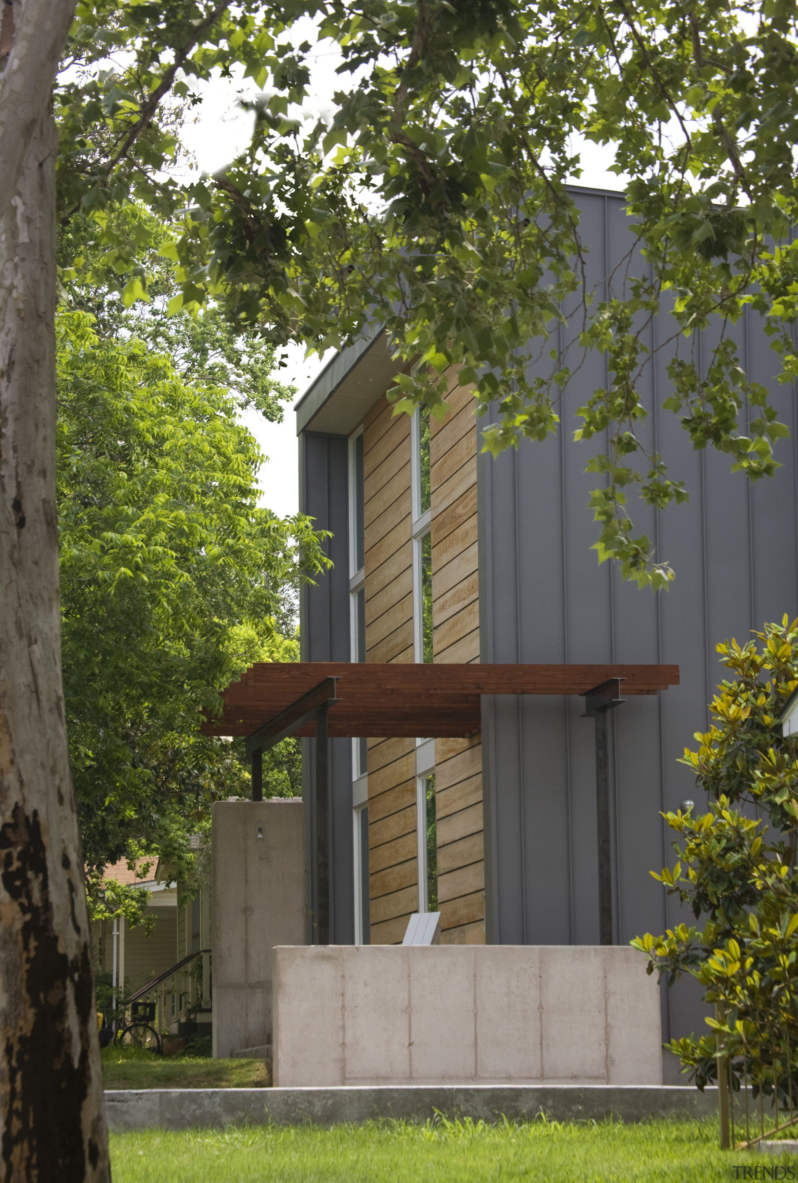 Exterior view of this contemporary remodeled home - architecture, building, cottage, facade, home, house, neighbourhood, property, real estate, residential area, tree, brown, gray