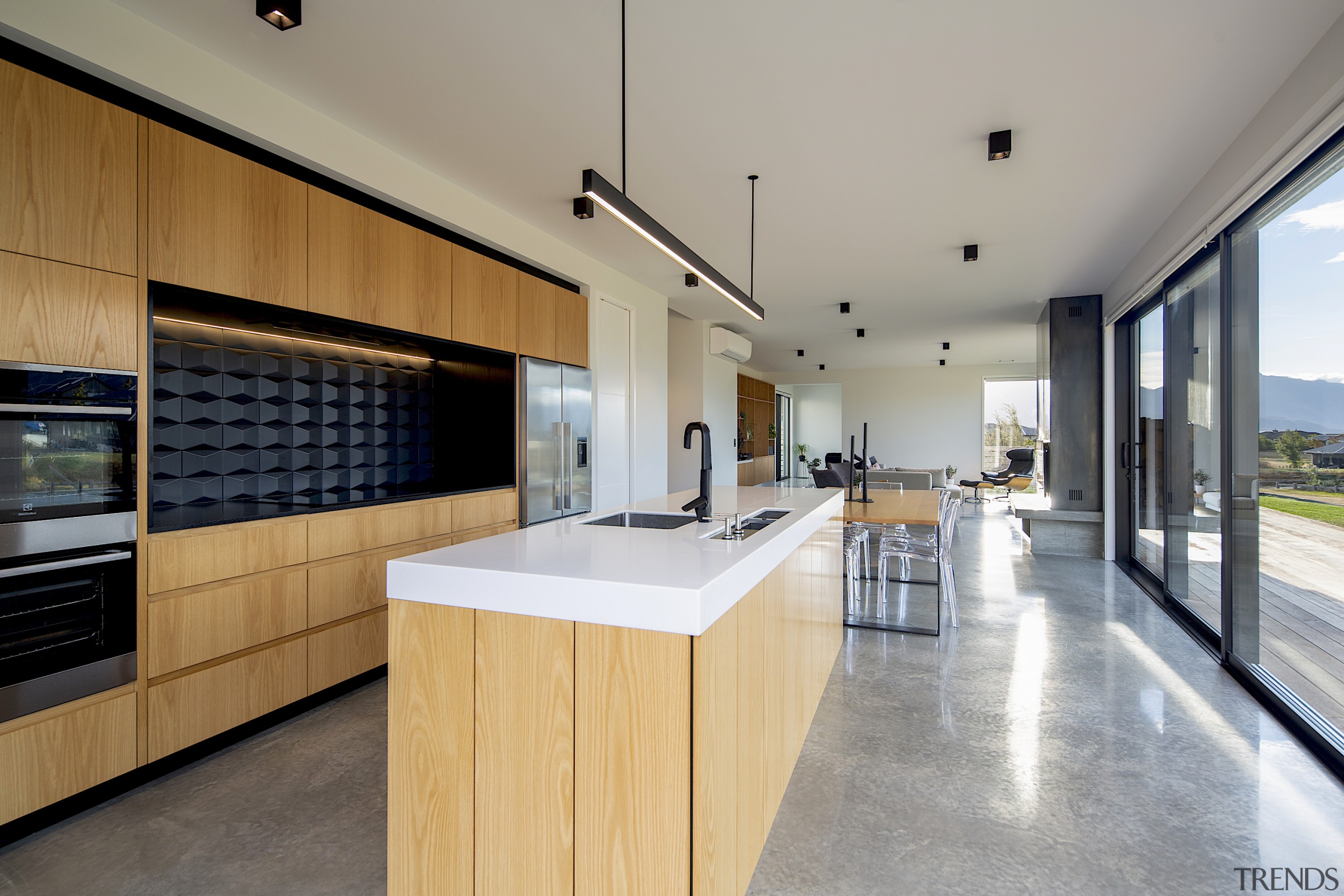 Wood cabinetry finishes and a polished concrete floor gray