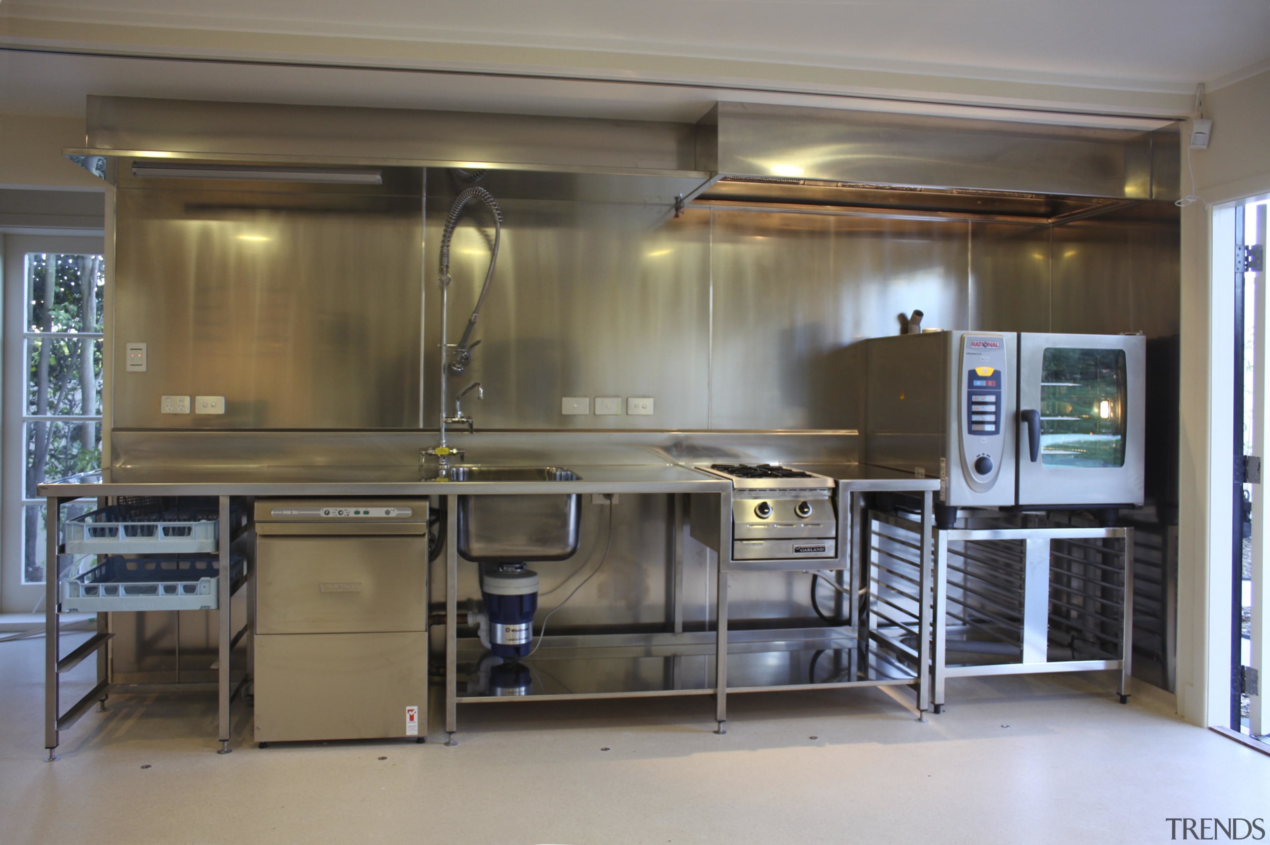 This scullery-style commercial kitchen was built for entertaining. cabinetry, countertop, kitchen, gray