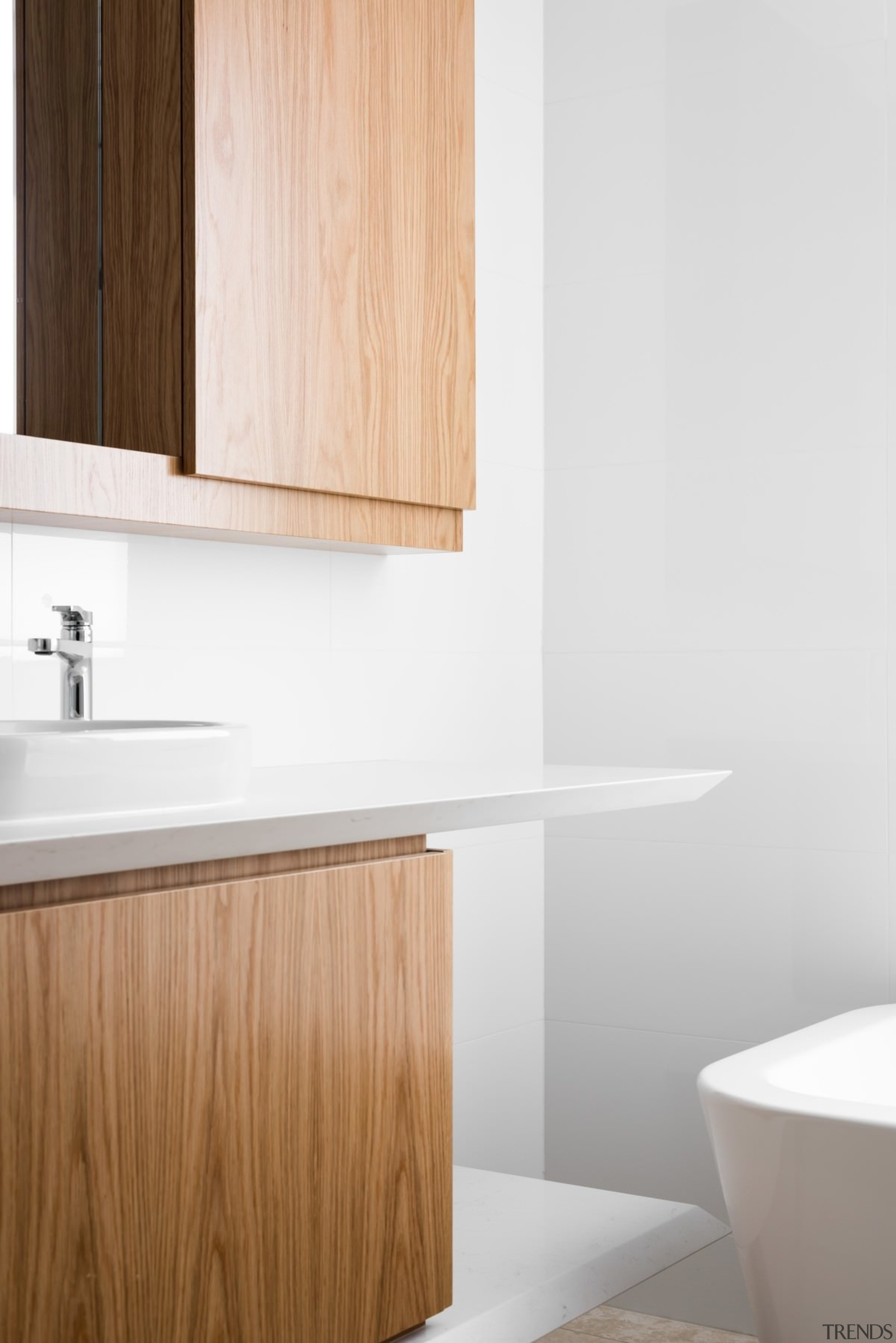 Wood cabinets in the bathroom are a nice bathroom, bathroom accessory, bathroom cabinet, bathroom sink, floor, hardwood, interior design, plumbing fixture, plywood, product, product design, sink, tap, tile, wall, wood, white