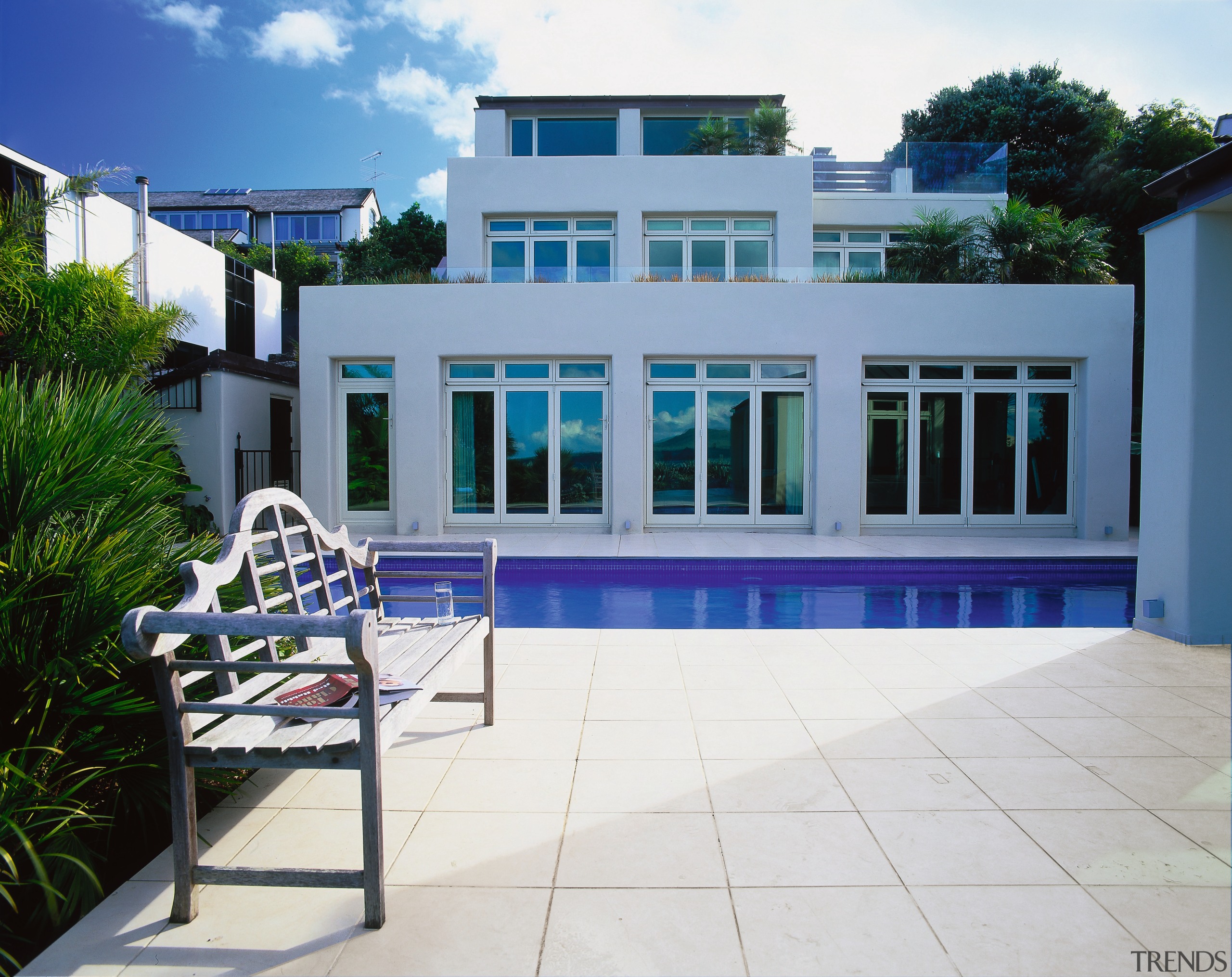 View of the home by the pool - apartment, condominium, estate, facade, home, house, property, real estate, residential area, swimming pool, villa, window, white