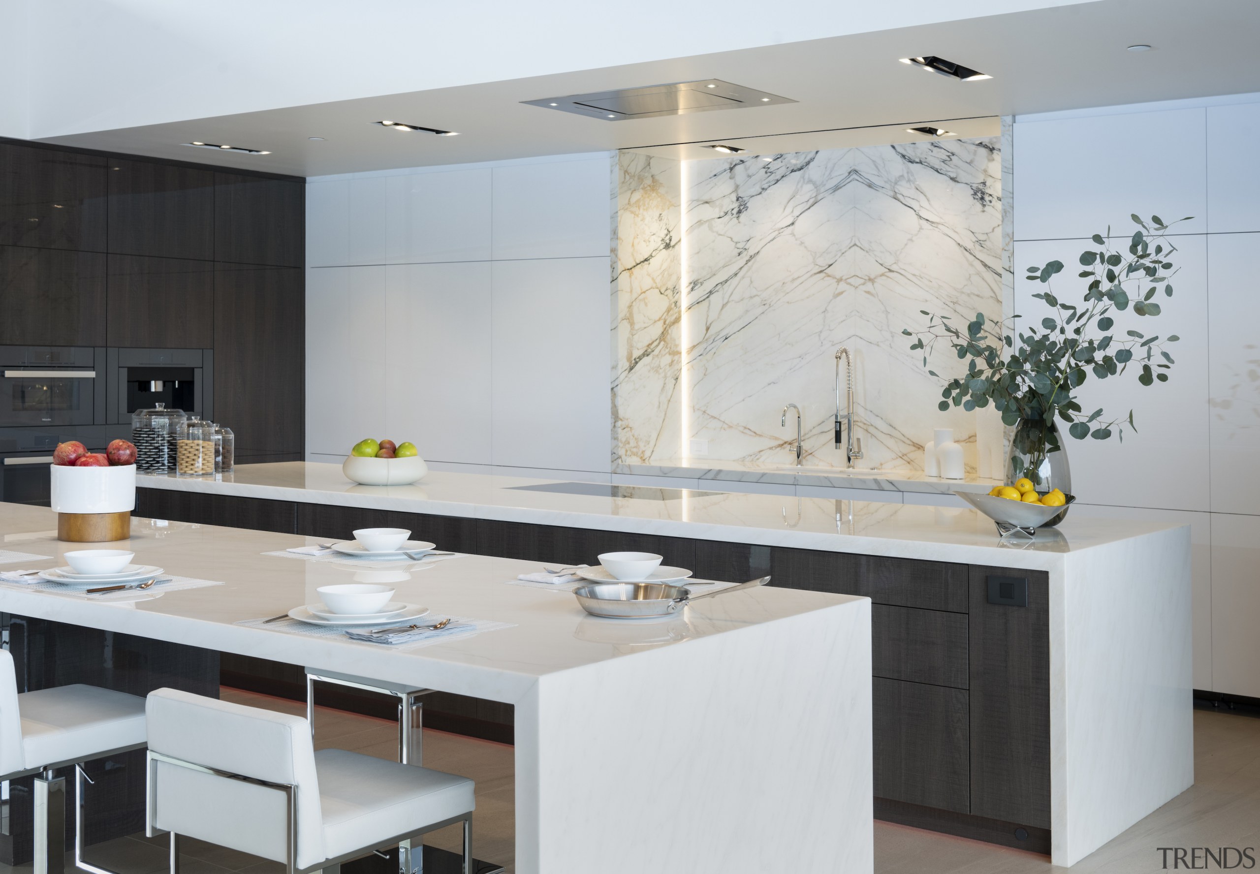 The all-white chef’s kitchen with Miele appliances, cabinets 
