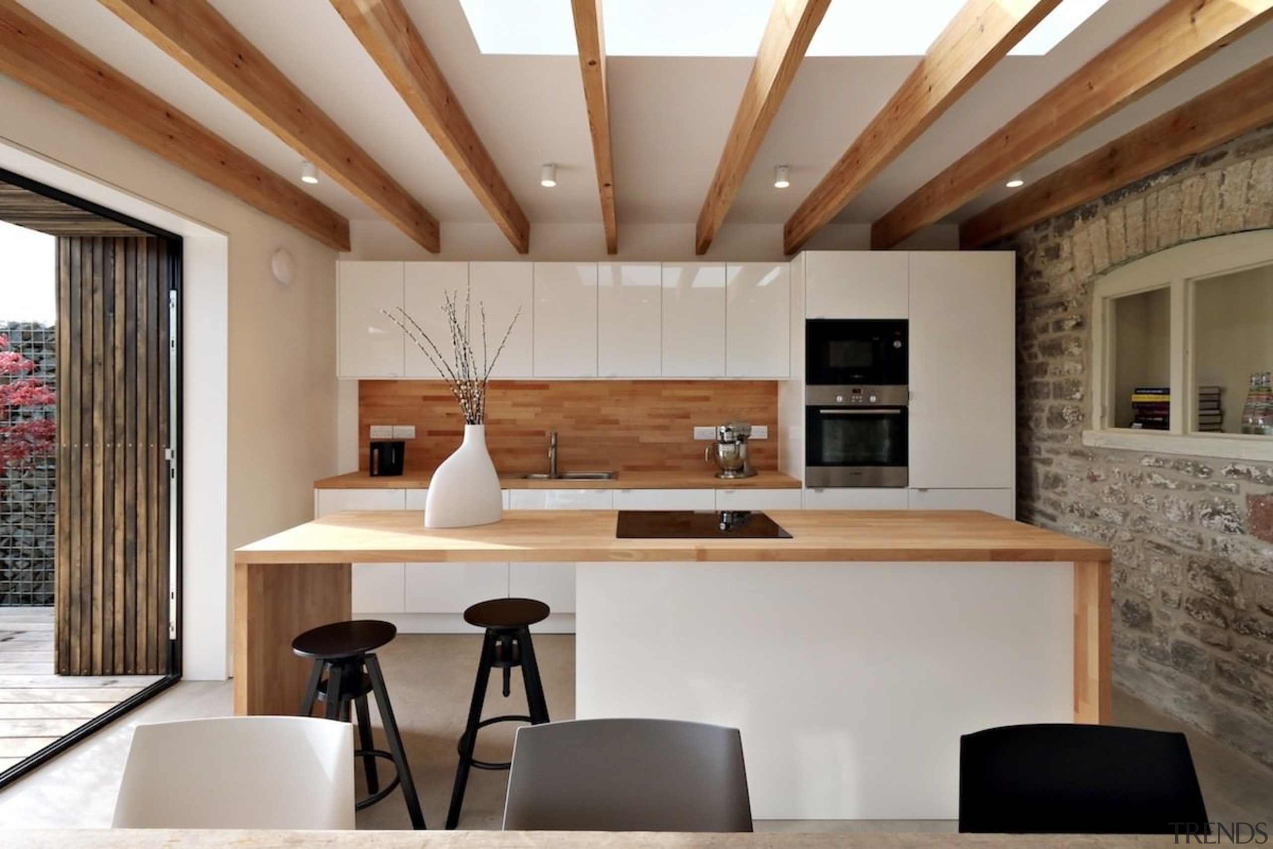 Wood accents tie this glossy white kitchen together architecture, ceiling, countertop, interior design, kitchen, table, gray, brown