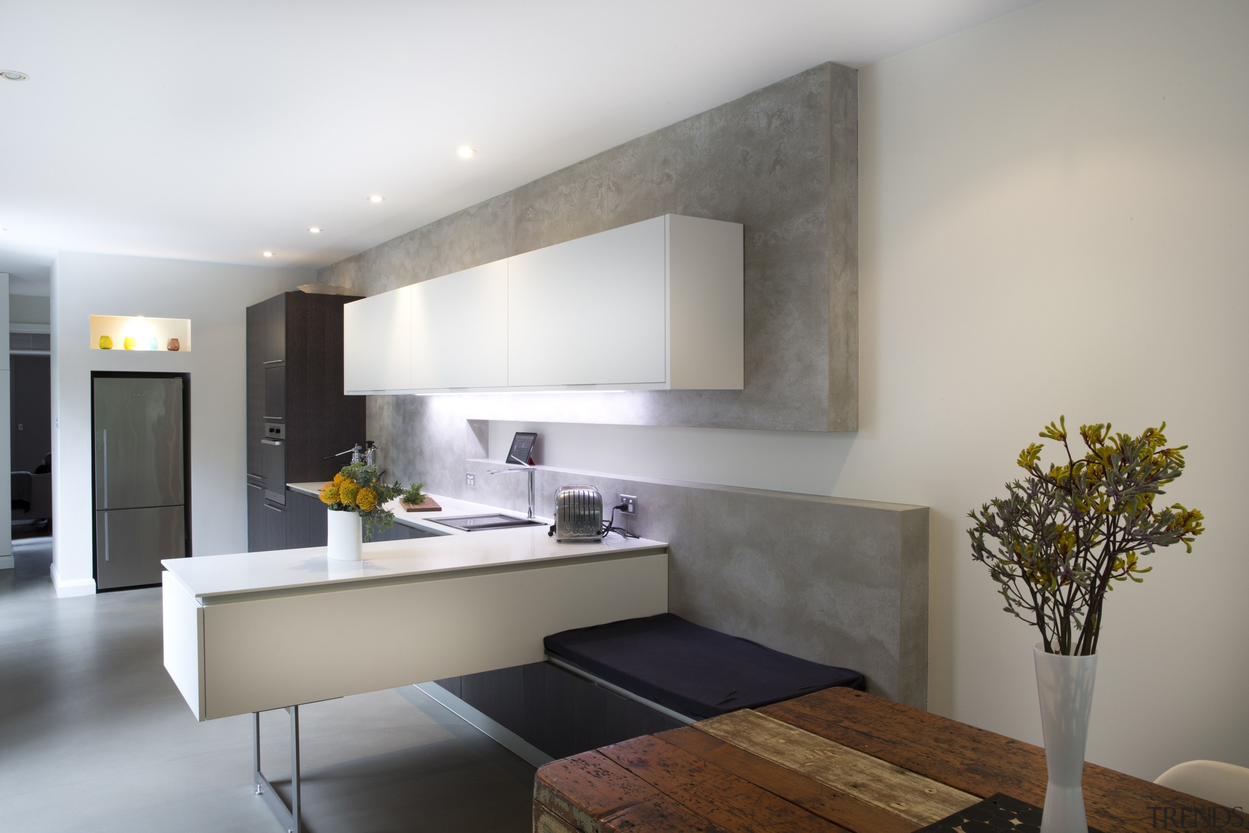 Geometric forms define this new kitchen designed by architecture, ceiling, interior design, interior designer, living room, real estate, room, wall, gray