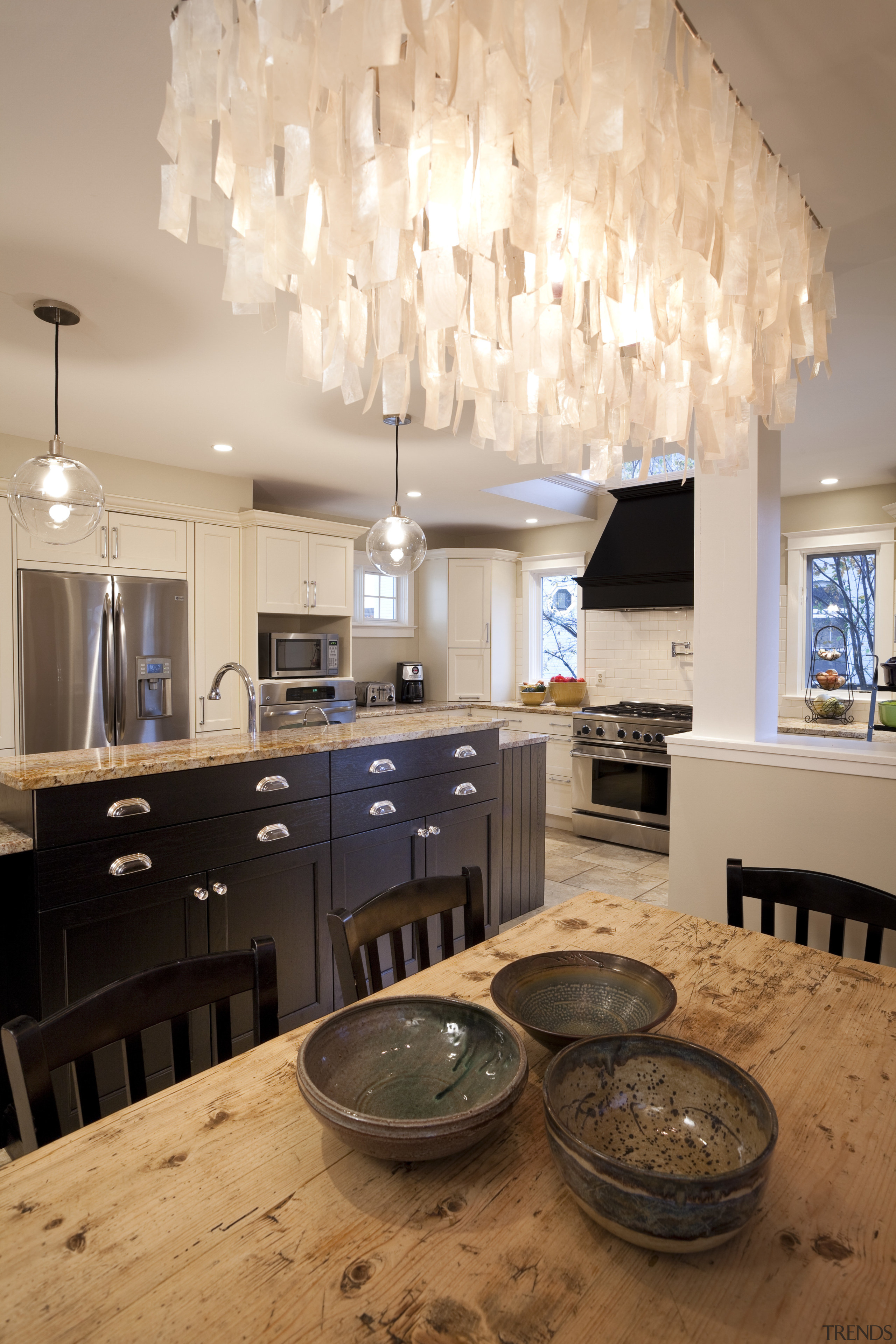 This kitchen was designed by Nadia Subaran of ceiling, countertop, dining room, home, interior design, kitchen, light fixture, lighting, room, table, orange
