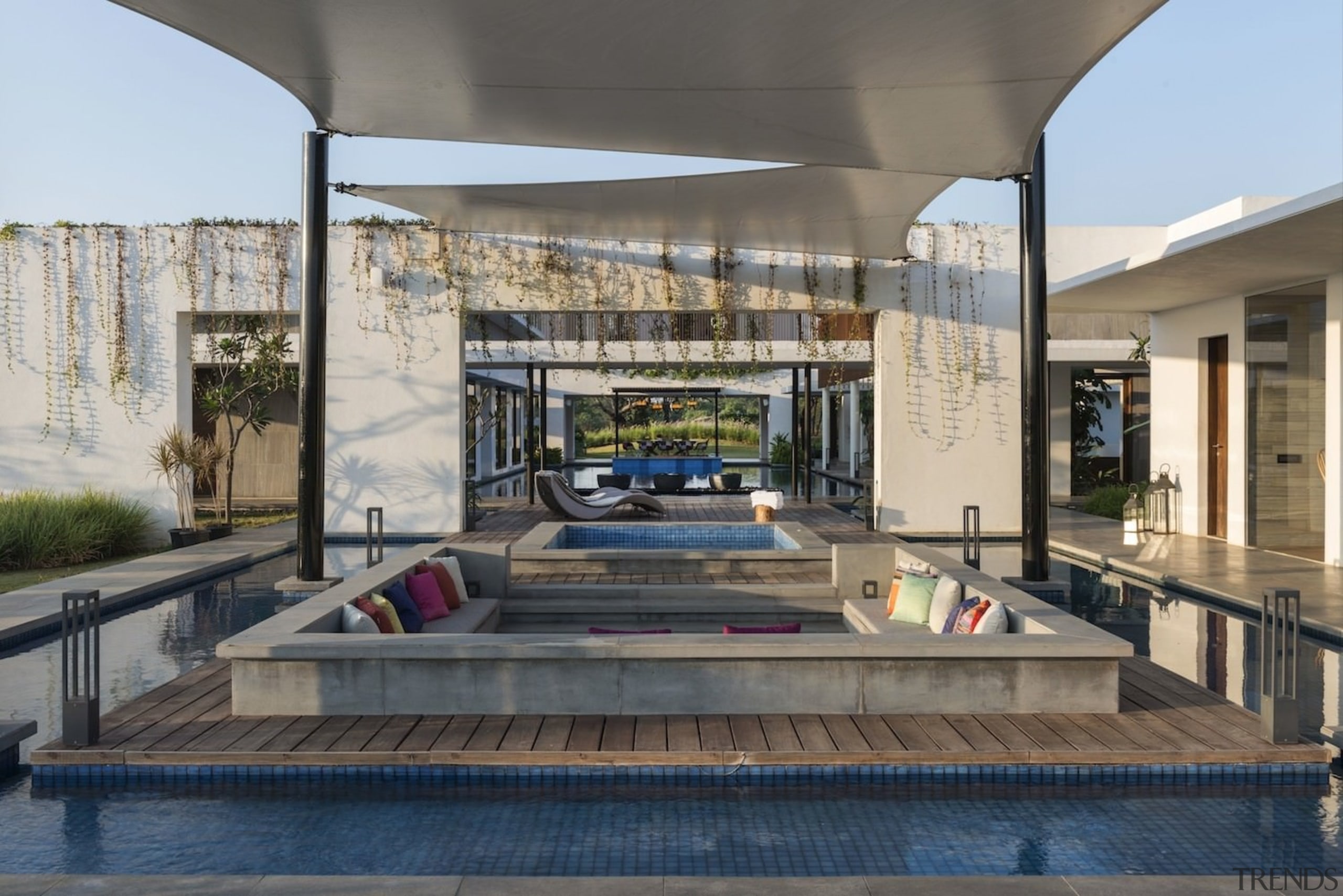 A sunken seating area outside receives shelter from real estate, gray