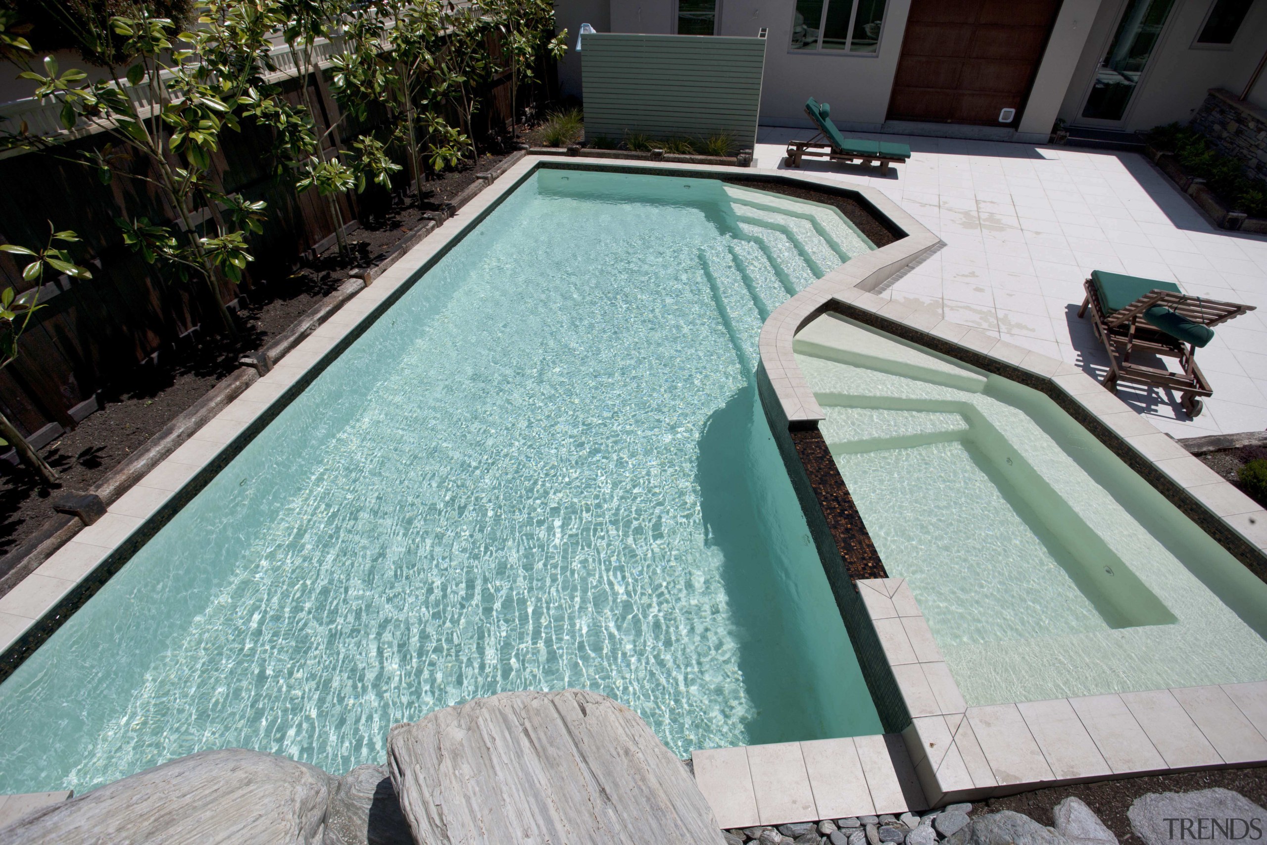 View of contemporary house with pool. - View backyard, leisure, pool, property, swimming pool, water, teal, black, gray