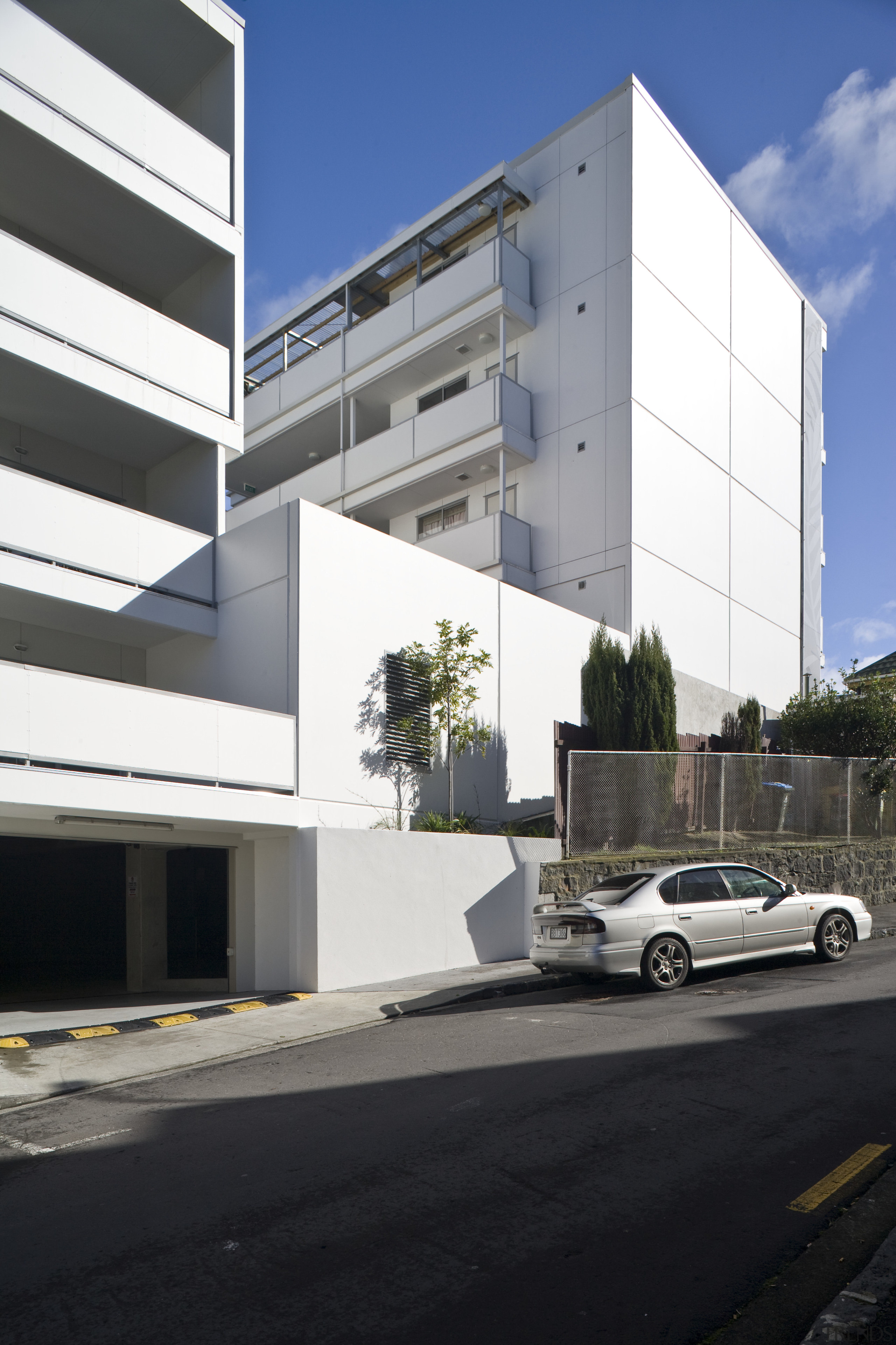 Exterior view of the Ivory apartments which features architecture, building, car, commercial building, condominium, corporate headquarters, elevation, facade, headquarters, house, luxury vehicle, metropolitan area, mixed use, residential area, sky, black, white