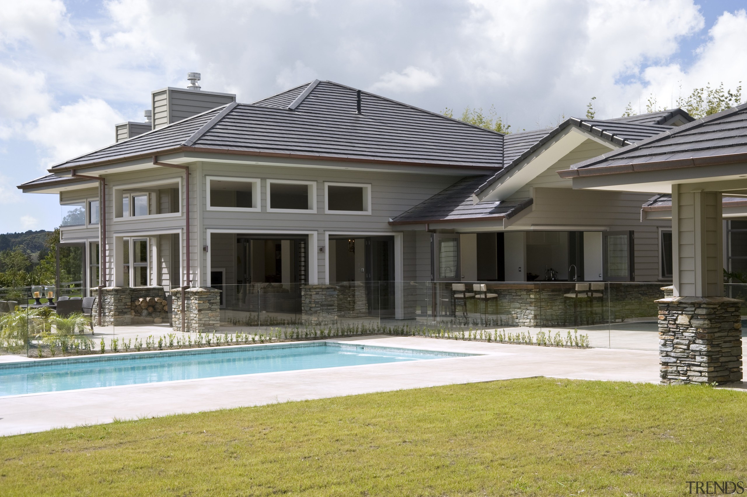 Image of this new home which features Artisan backyard, cottage, elevation, estate, facade, home, house, mansion, official residence, property, real estate, residential area, roof, siding, swimming pool, villa, window, white