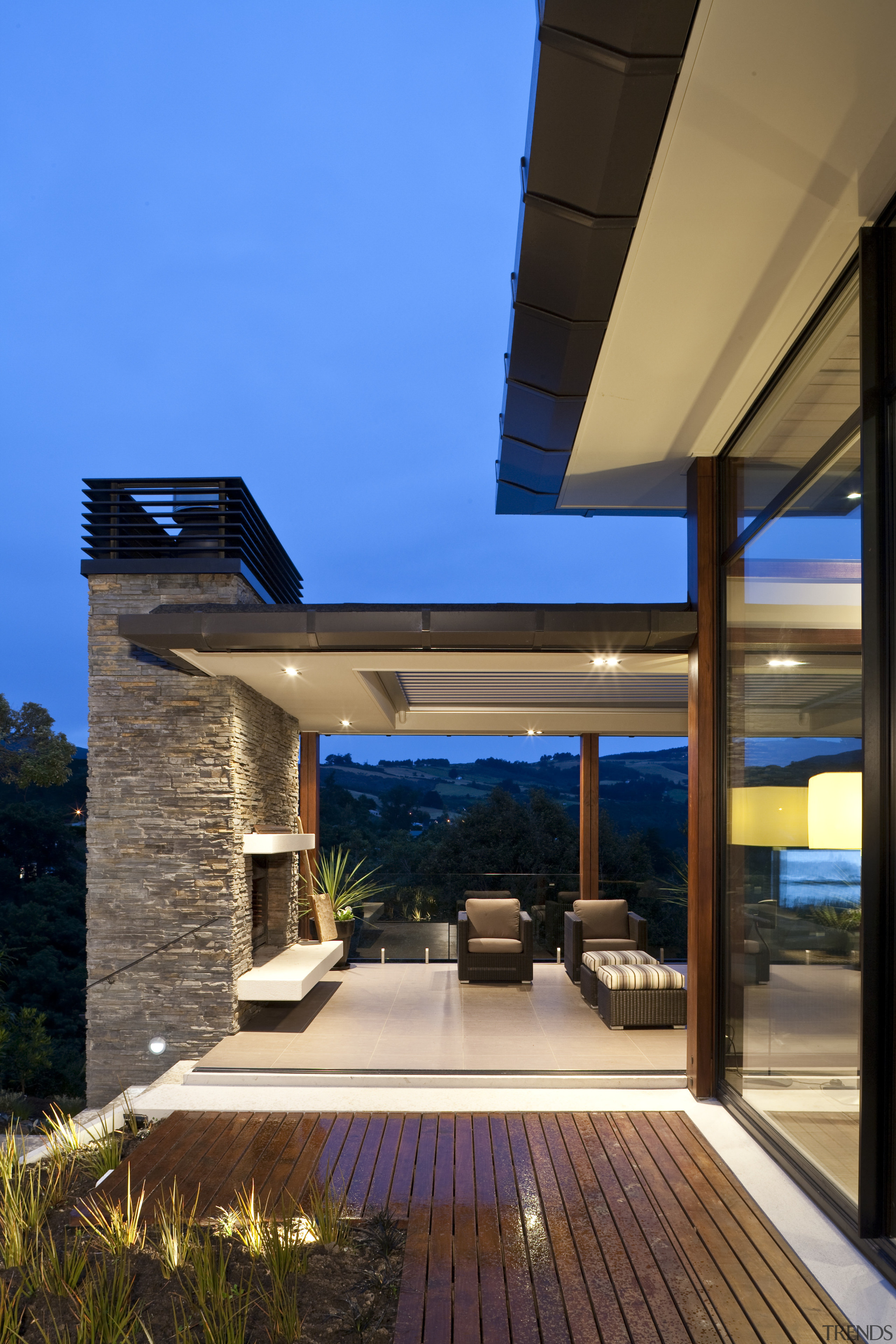 Exterior view of home which features a flat architecture, daylighting, estate, home, house, interior design, lighting, outdoor structure, real estate, residential area, roof, sky, teal, brown