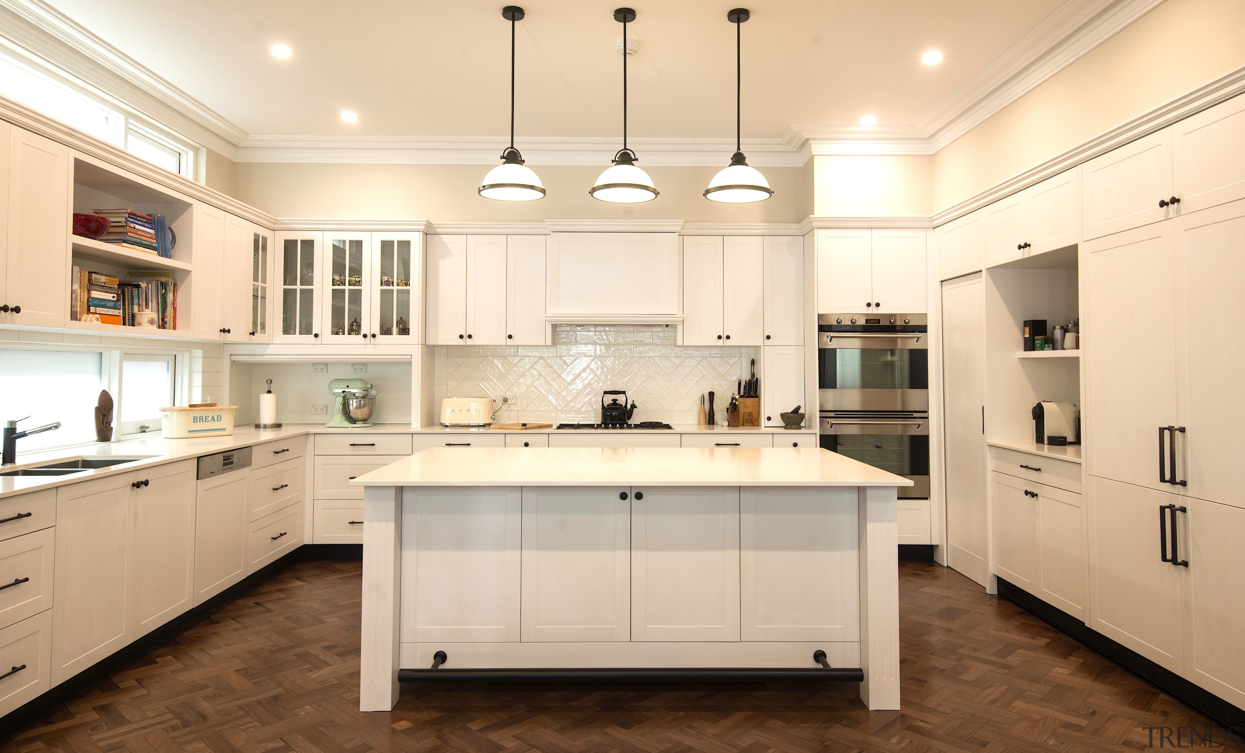 Classic pendants are matched with modern slender countertops building, cabinetry, ceiling, countertop, cuisine classique, cupboard, floor, flooring, furniture, hardwood, home, house, interior design, kitchen, light fixture, lighting, material property, property, real estate, room, sink, tile, wood flooring, orange