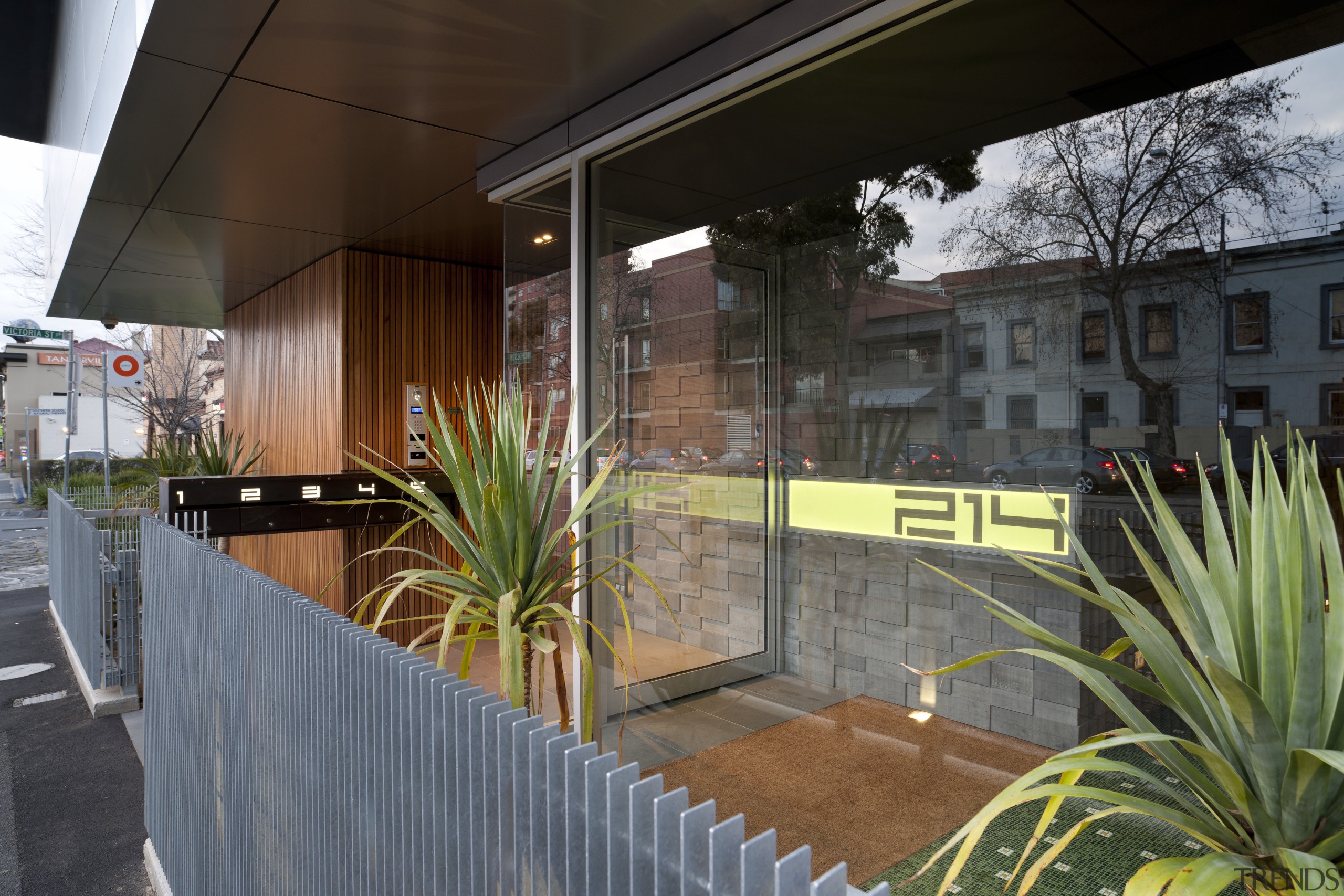 The main entry to the Rolo apartment building apartment, architecture, facade, home, house, real estate, tree, window, gray, black