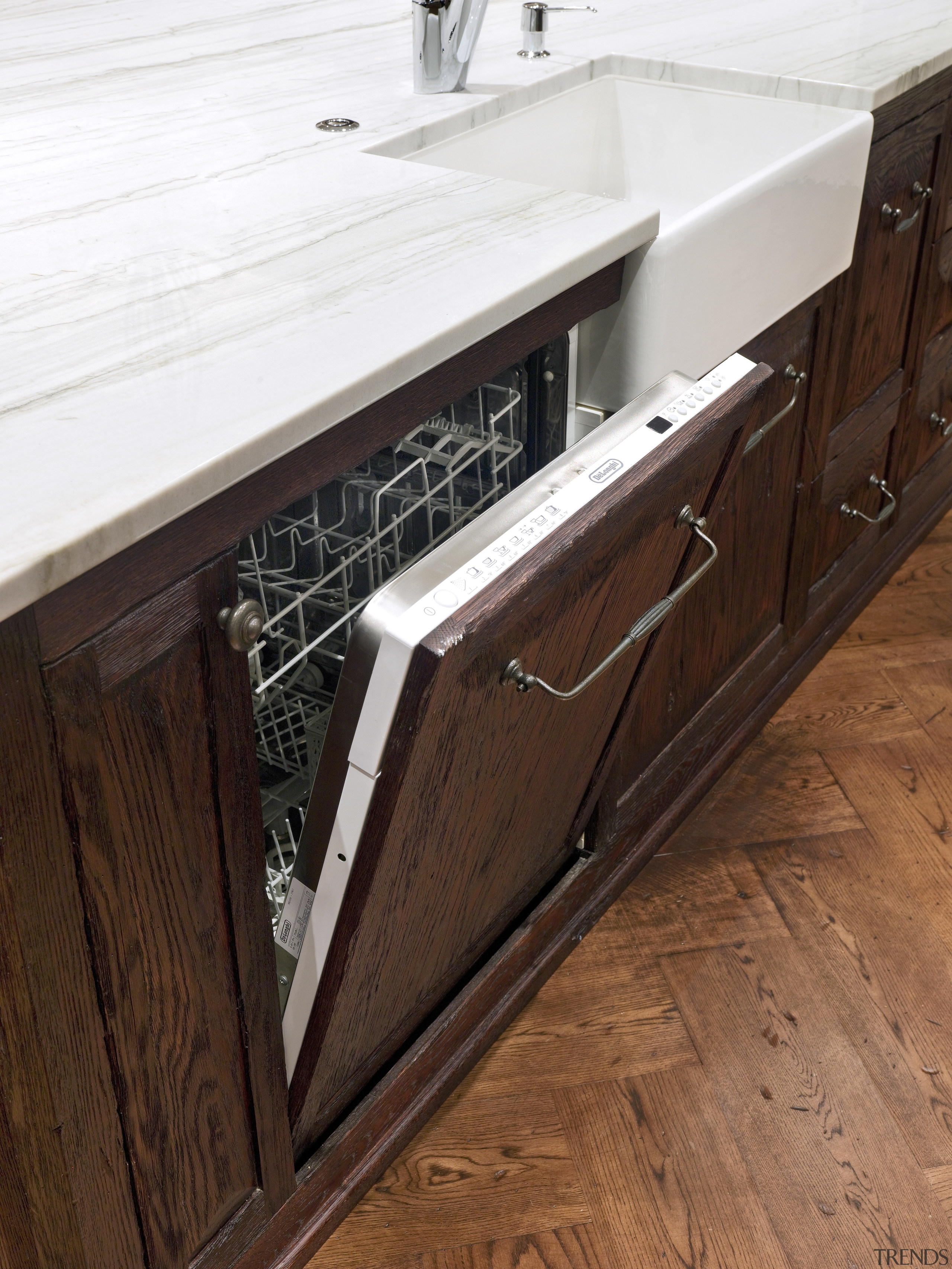 A view of some kitchen appliances from De'Longhi. cabinetry, countertop, drawer, floor, flooring, furniture, hardwood, sink, wood, wood stain, brown, white