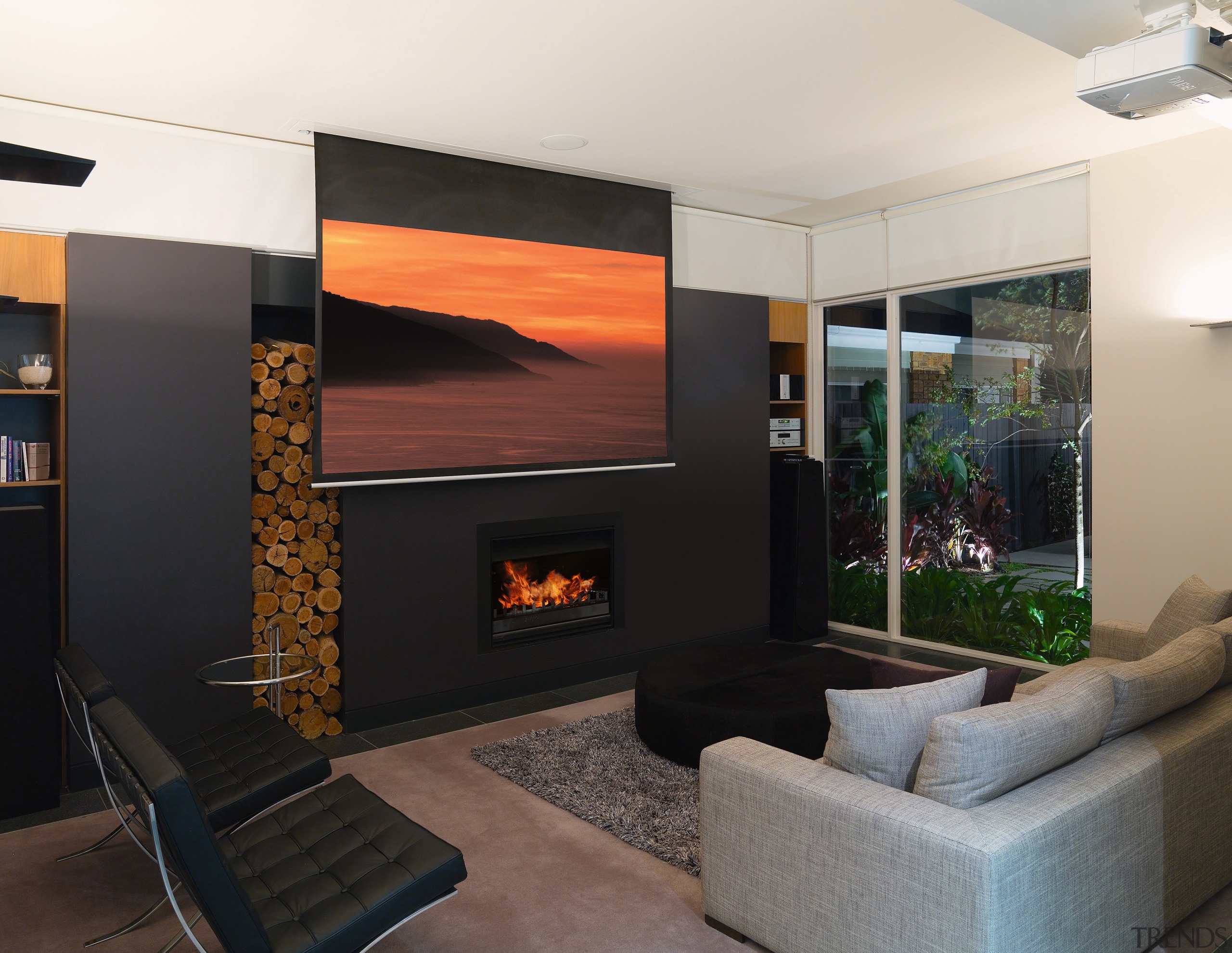 A second living area, which doubles as a fireplace, hearth, interior design, living room, wall, black, white