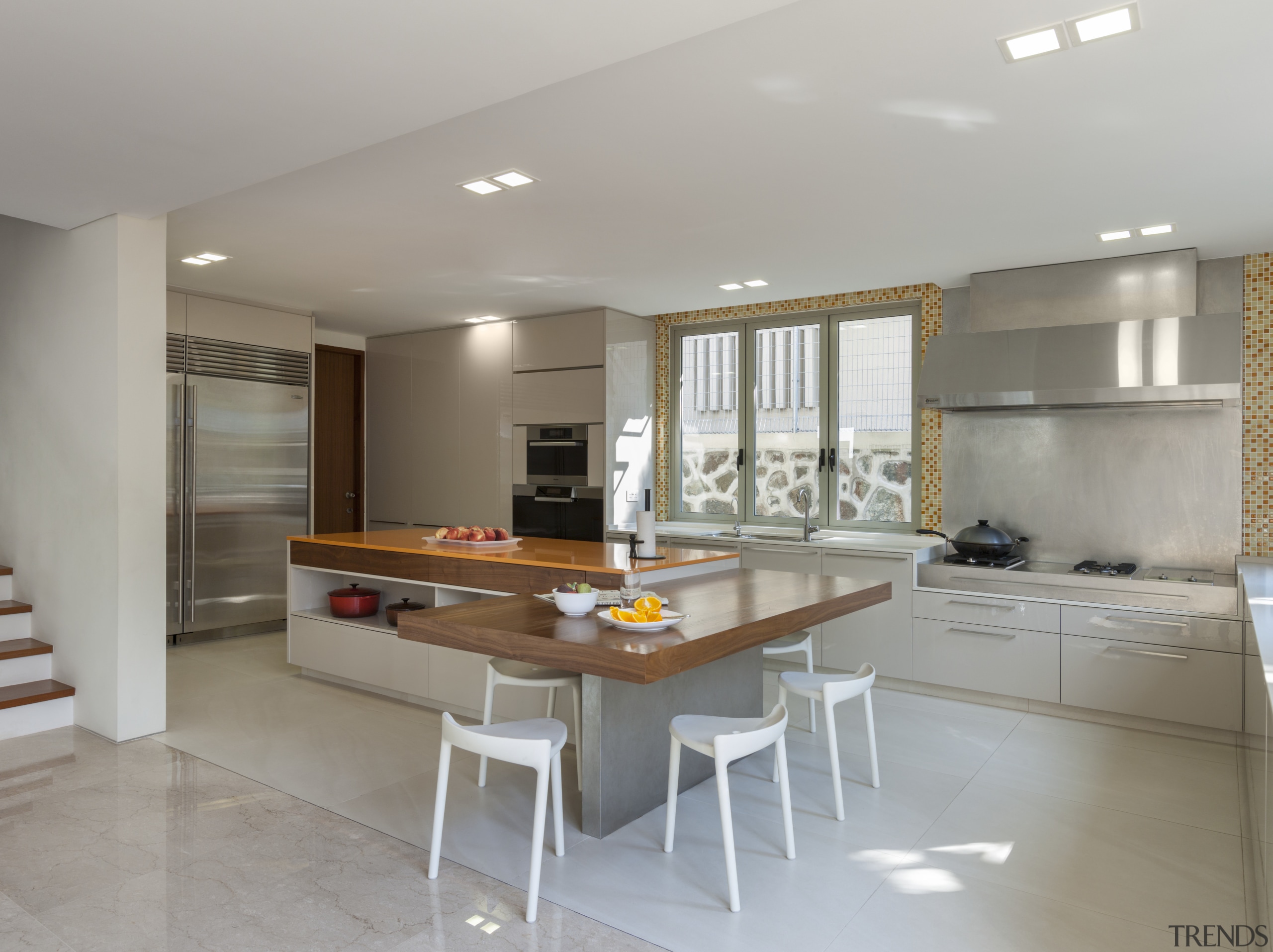 The kitchen in this home incorporates an L-shaped cabinetry, ceiling, countertop, floor, flooring, interior design, kitchen, real estate, room, gray