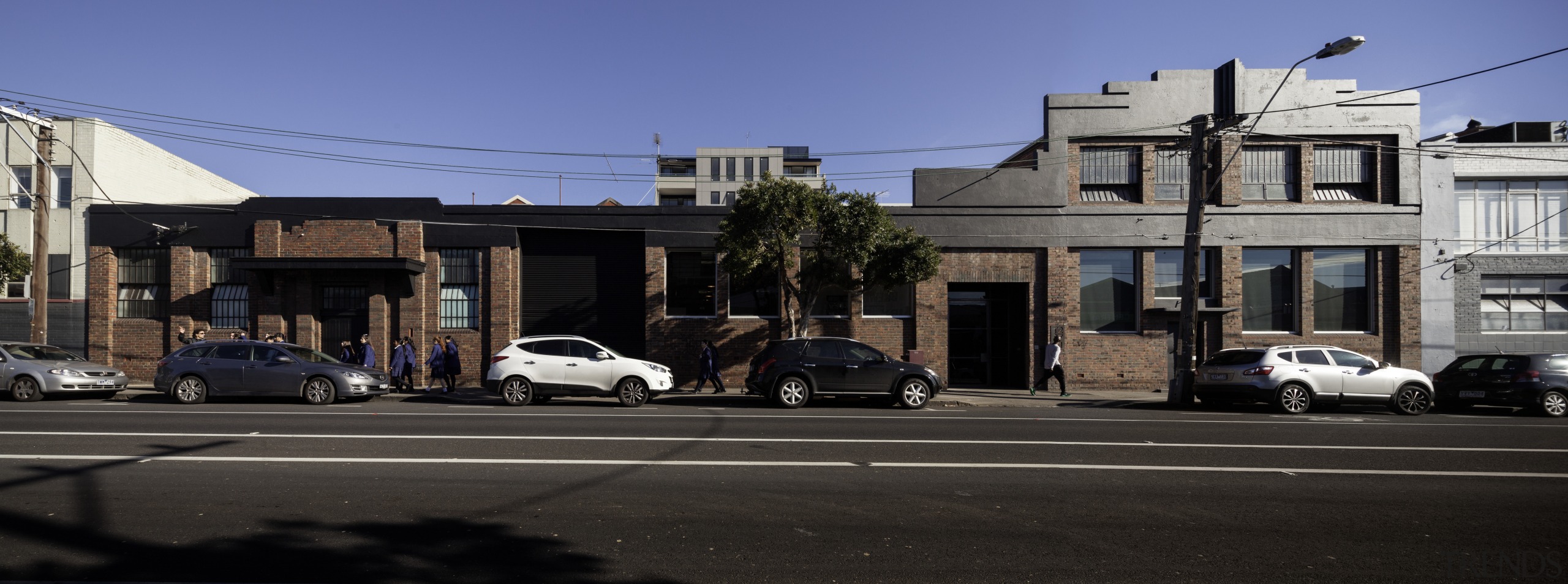 A former industrial warehouse in Melbourne is home architecture, building, car, city, compact car, downtown, facade, family car, house, infrastructure, lane, luxury vehicle, neighbourhood, real estate, residential area, road, sedan, sky, street, suburb, town, transport, urban area, vehicle, black