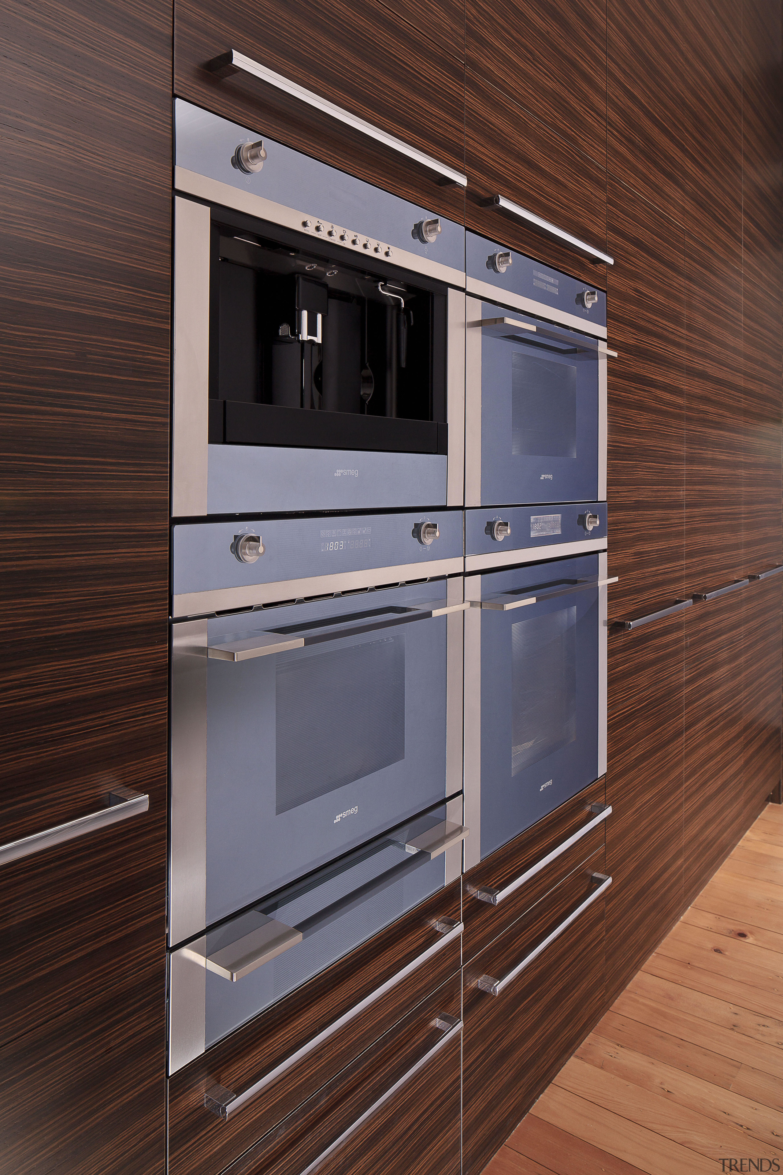 Contemporary ovens with wooden cabinetry and drawers. cabinetry, countertop, floor, home appliance, kitchen, kitchen appliance, kitchen stove, major appliance, oven, red, gray