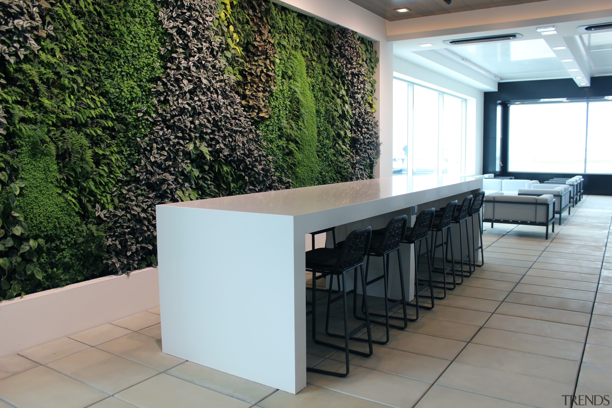 This indoor-outdoor terrace  complete with living wall floor, flooring, furniture, interior design, property, table, white