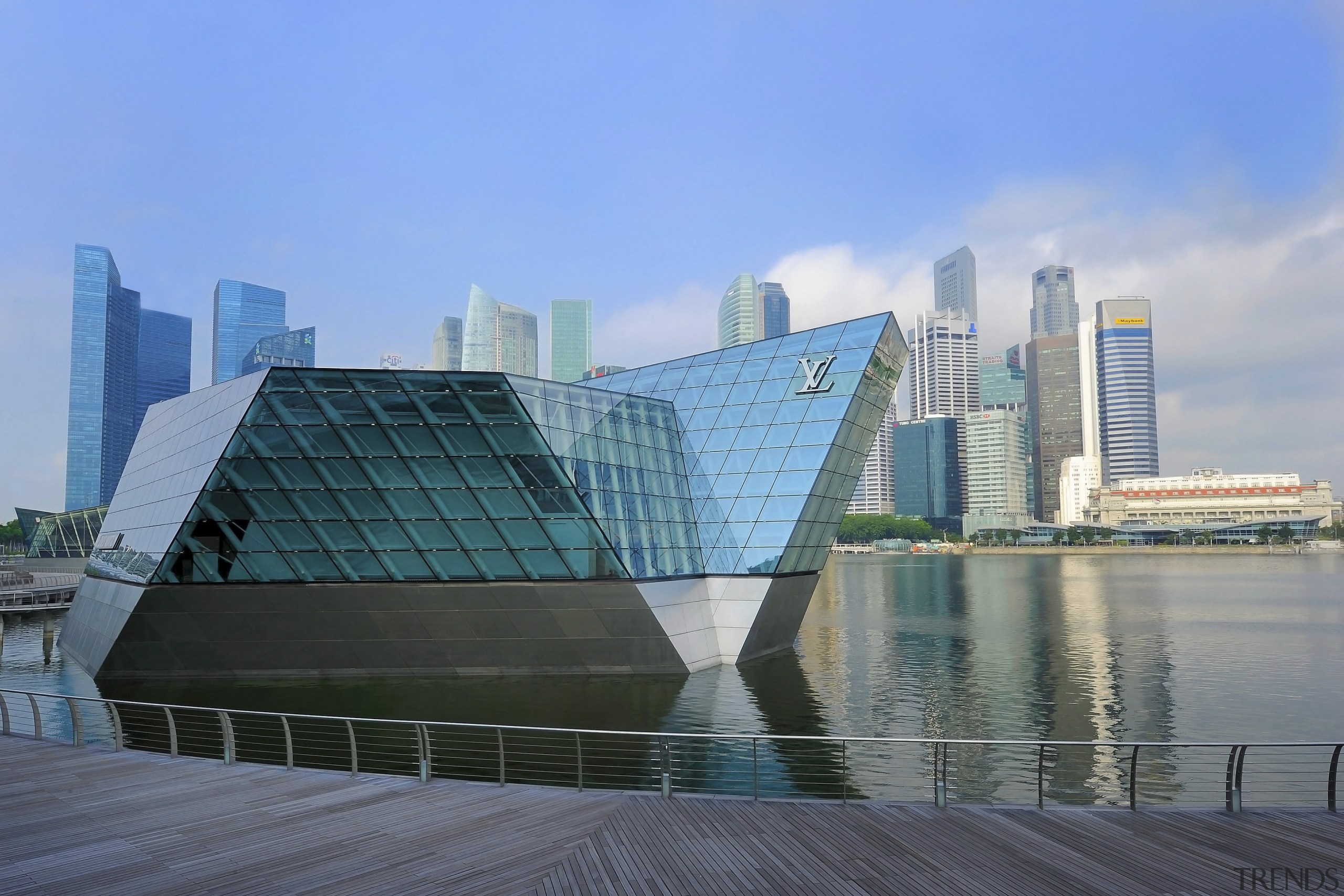 The Louis Vuitton Island Maison in Singapore appears architecture, building, city, cityscape, commercial building, condominium, corporate headquarters, daytime, downtown, fixed link, headquarters, landmark, metropolis, metropolitan area, mixed use, reflection, sky, skyline, skyscraper, tower block, urban area, water, teal, gray