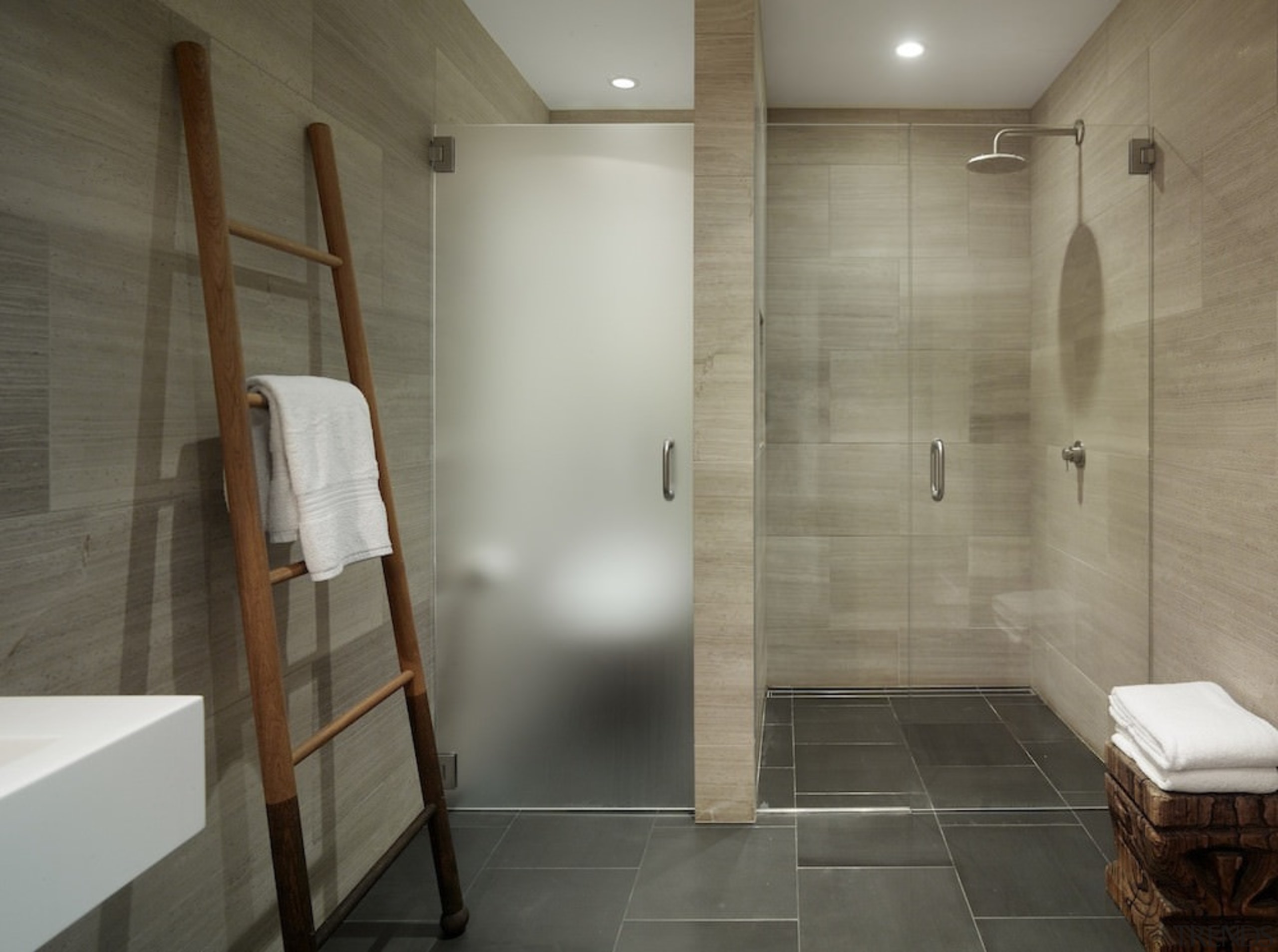 This bathroom features a toilet sealed from the architecture, bathroom, floor, flooring, interior design, plumbing fixture, real estate, room, tile, wall, gray