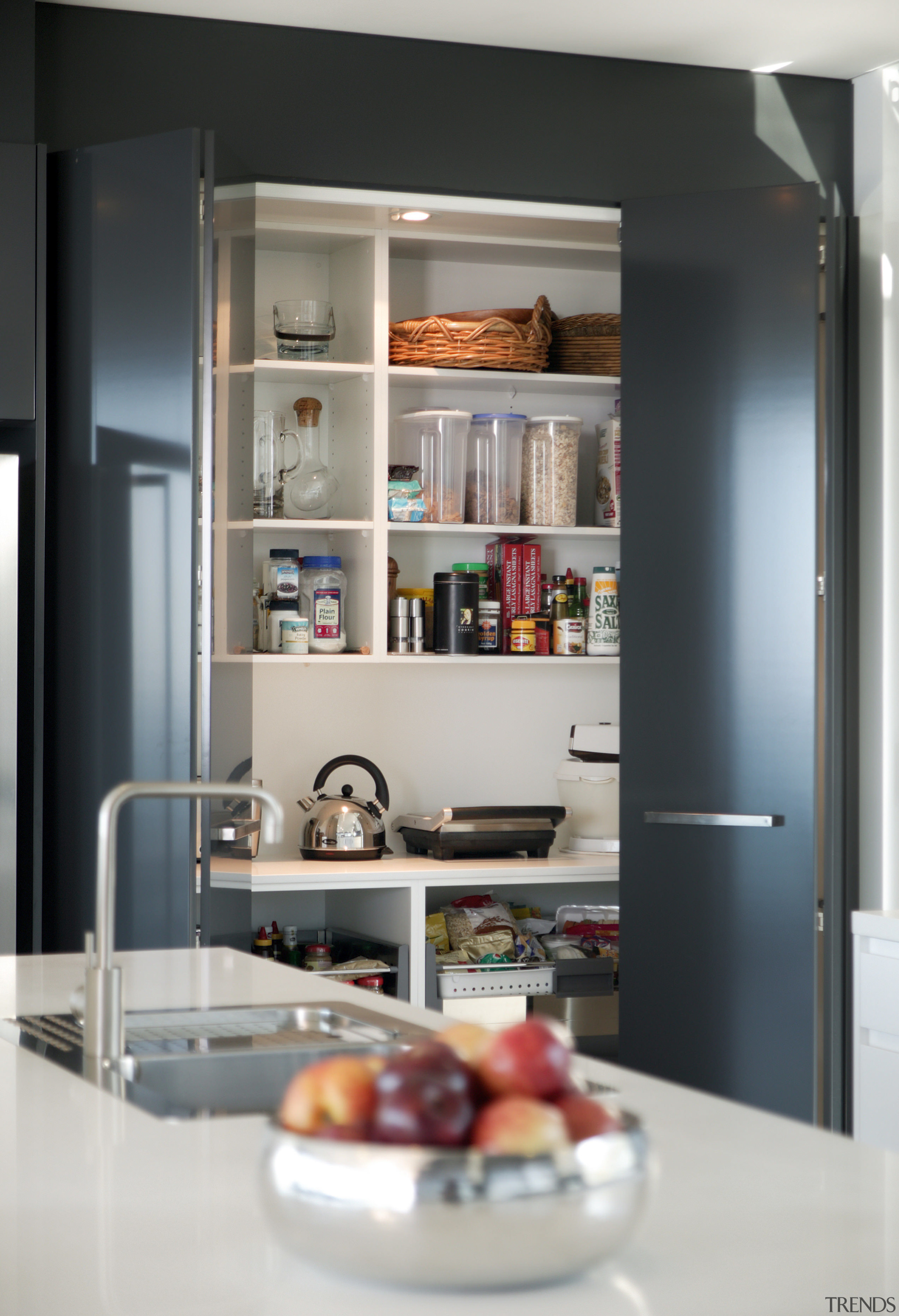 View of kitchen and dining area  designed furniture, interior design, kitchen, refrigerator, shelf, shelving, gray, black