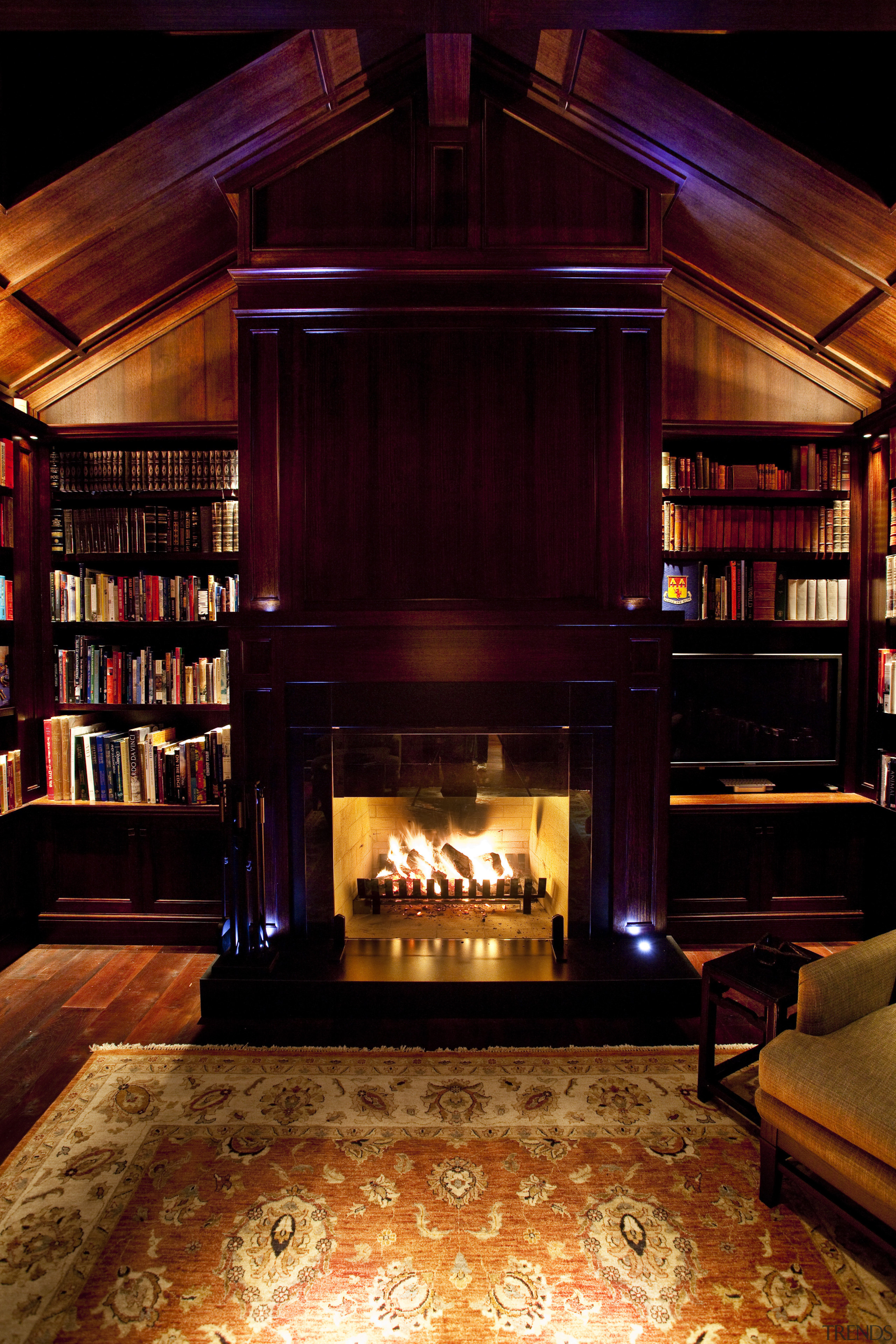 View of library with mat and fireplace. - bar, fireplace, hearth, home, interior design, lighting, lobby, wood, black