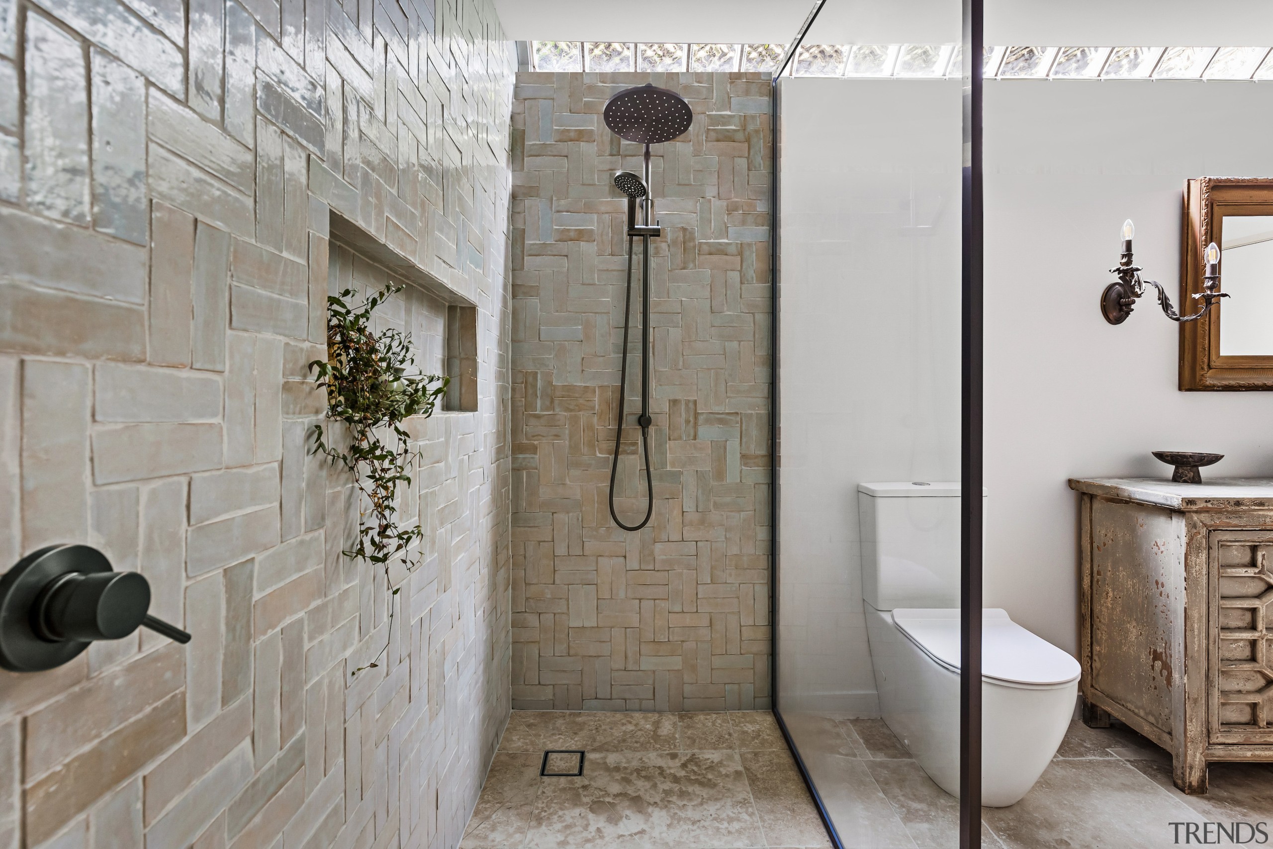 The light dapples across the handmade wall tiles, 