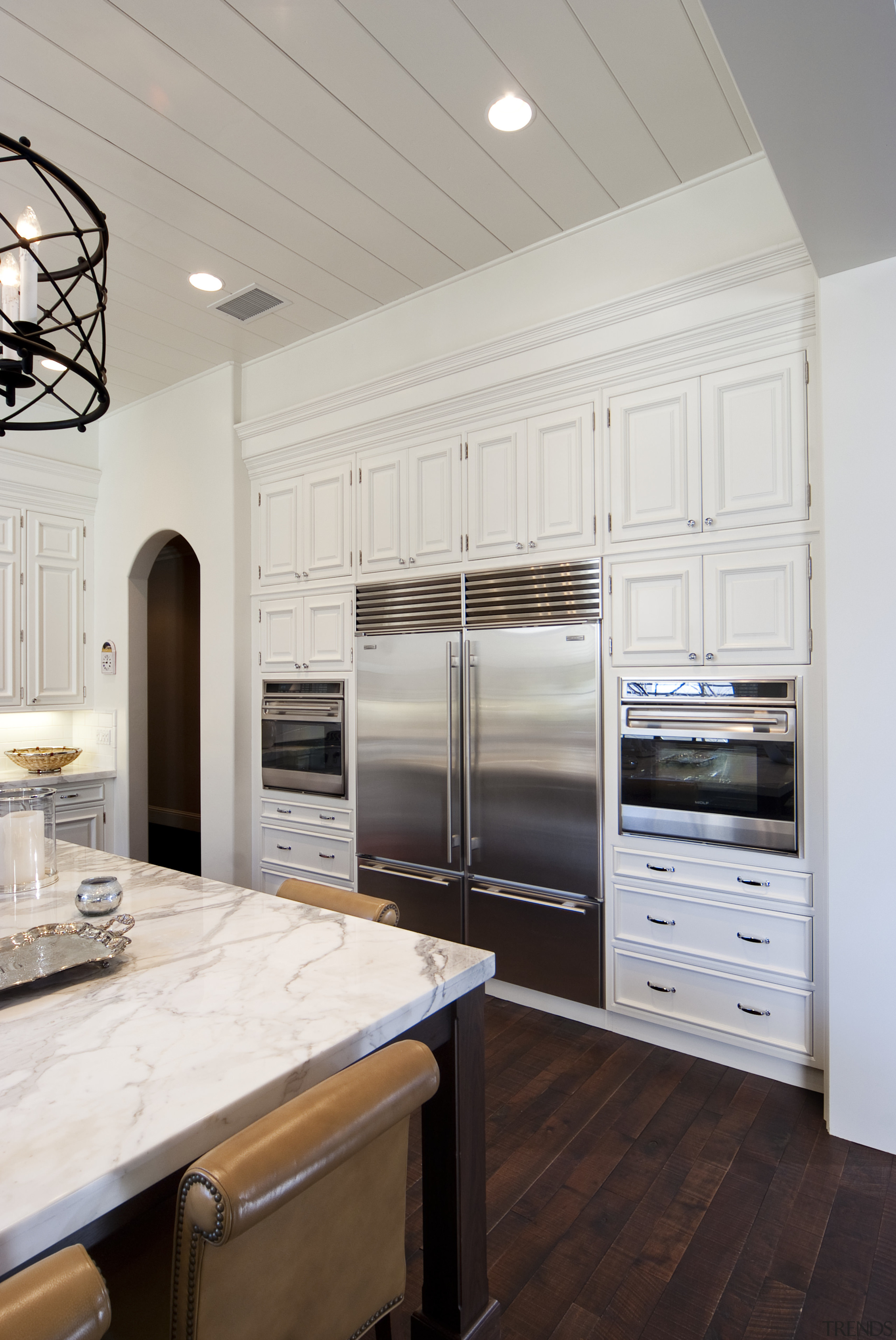 panelled cabinets, dark wood flooring, double door fridge, cabinetry, countertop, cuisine classique, floor, flooring, home appliance, interior design, kitchen, room, wood flooring, gray