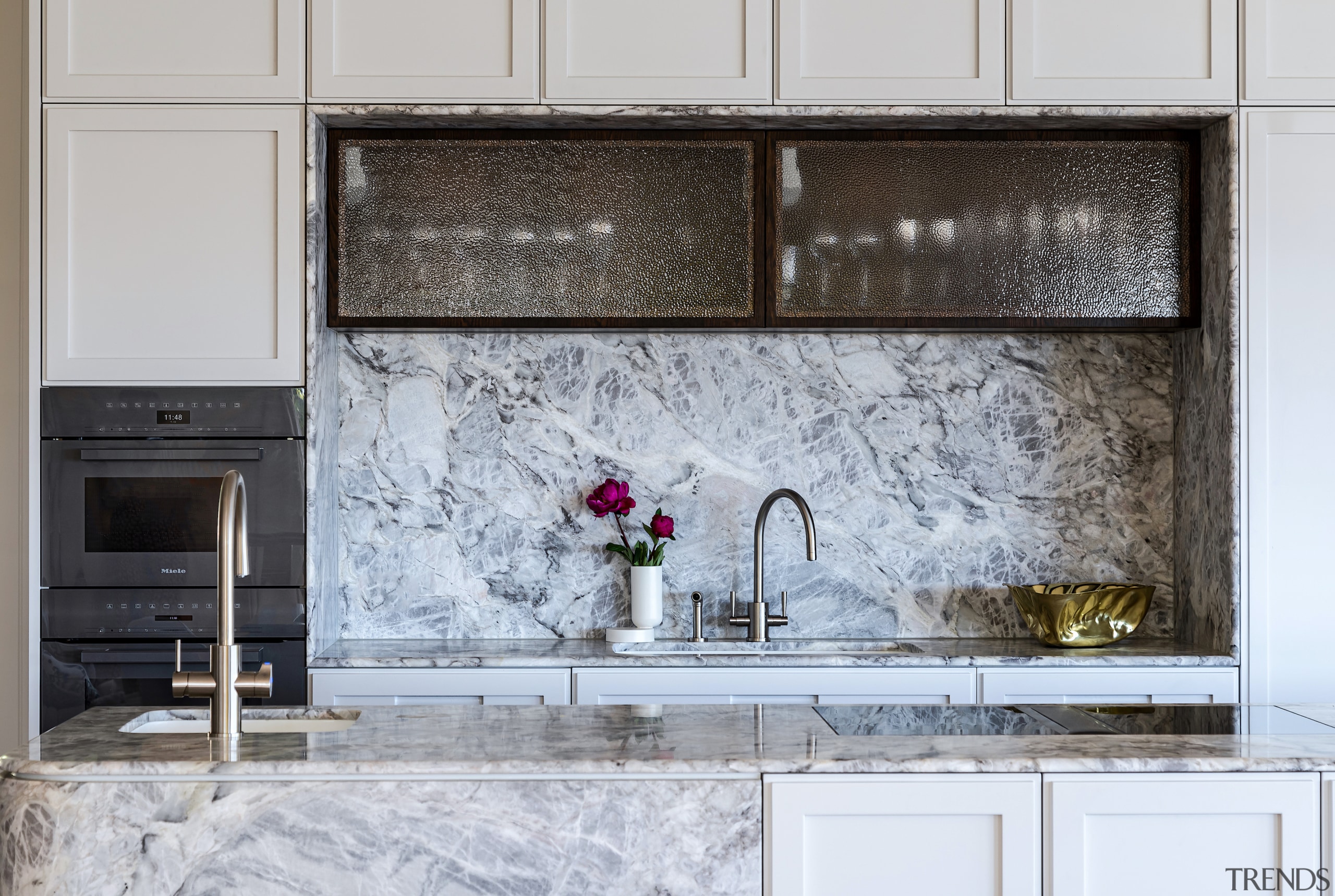 Custom hammered glass overheads add to the kitchen's 