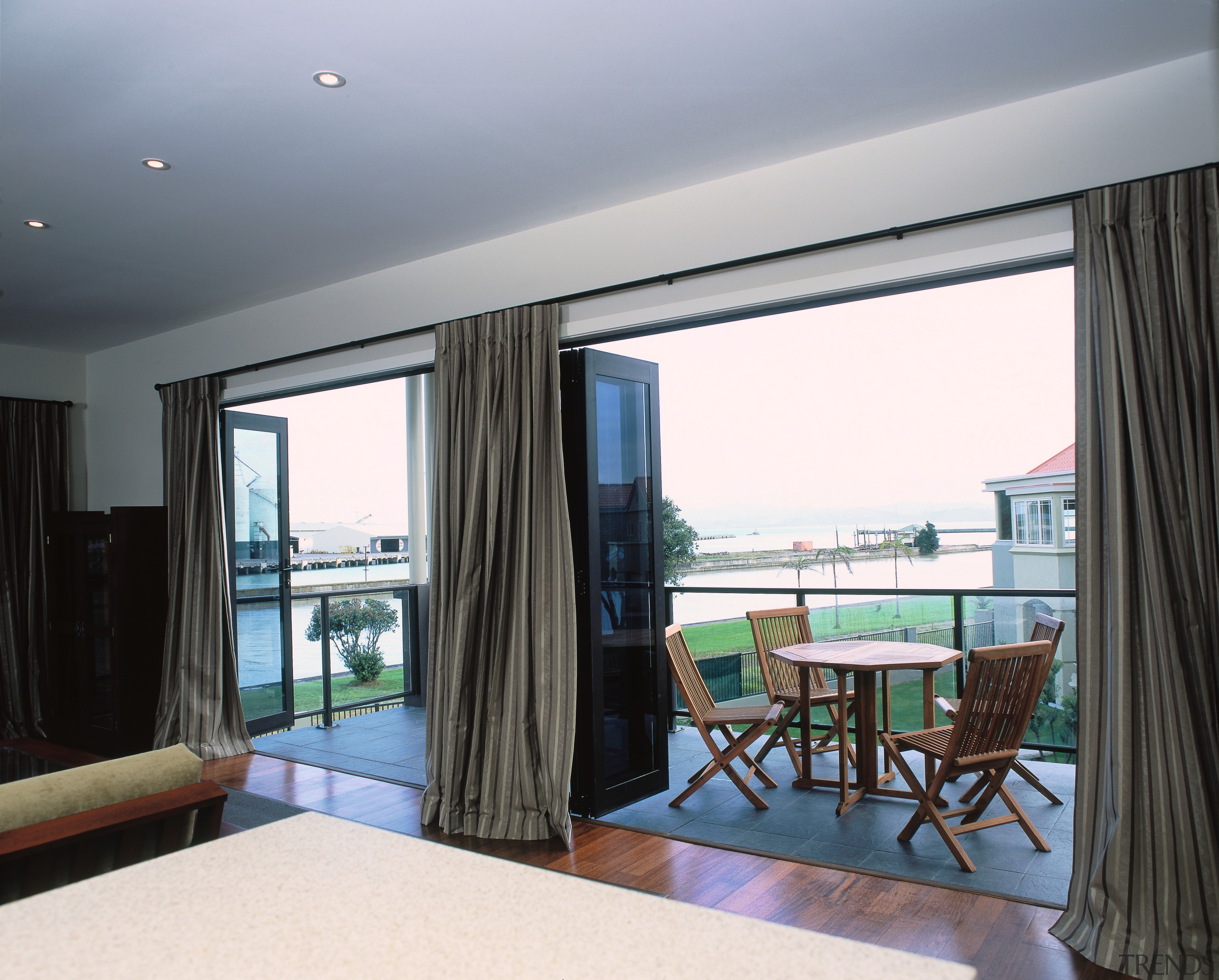 Hotel suite with powdercoated aluminium joinery, featuring bi-fold apartment, ceiling, condominium, interior design, property, real estate, room, suite, window, window treatment, gray, black