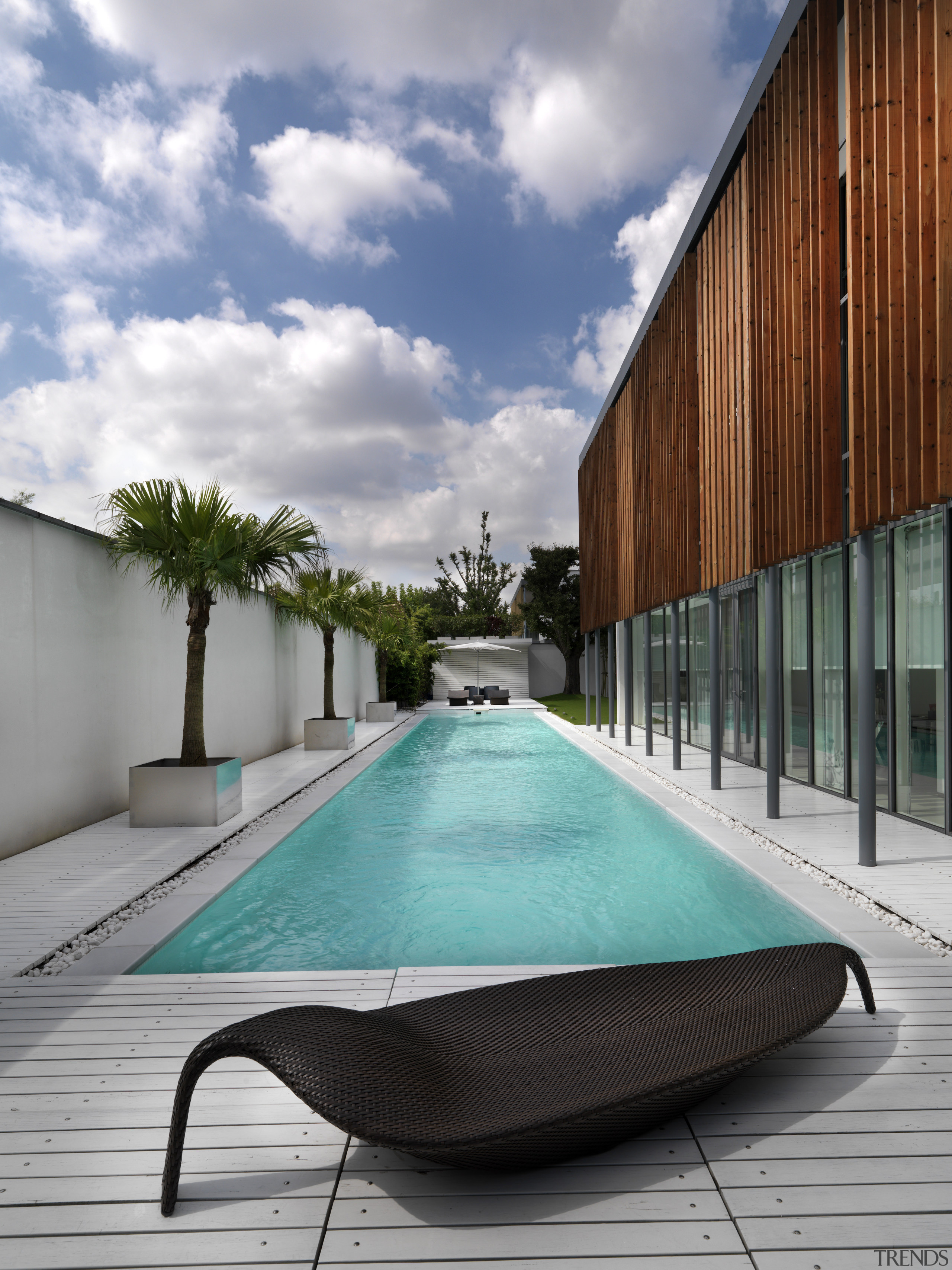 View of the outdoor area which features a architecture, condominium, house, leisure, real estate, reflection, sky, swimming pool, water, gray