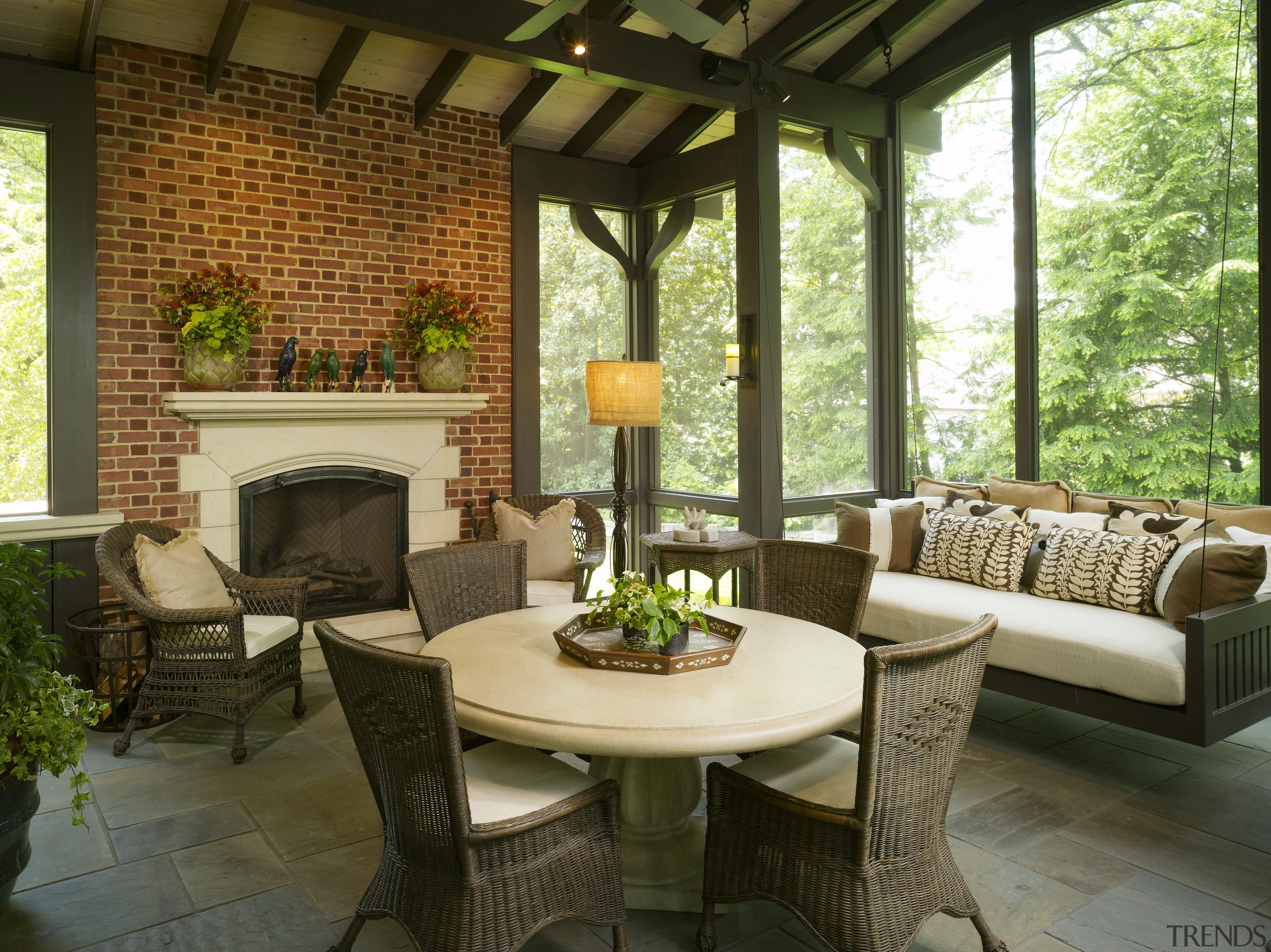 Traditional style living area featuring fireplace &amp; furniture backyard, home, interior design, living room, outdoor structure, patio, porch, real estate, table, window, brown