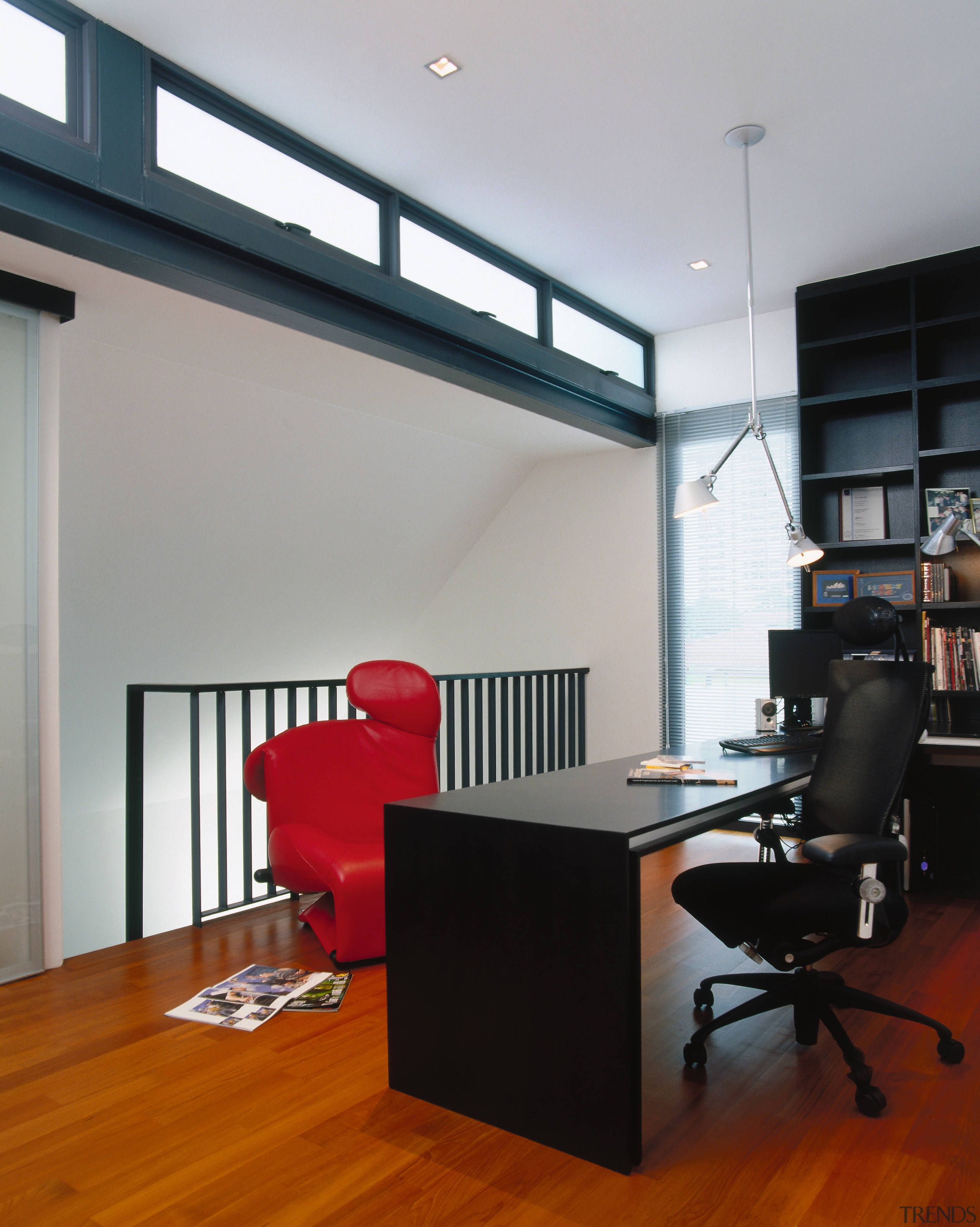 view of this medroom and study area featuring architecture, ceiling, desk, floor, flooring, furniture, interior design, loft, office, gray