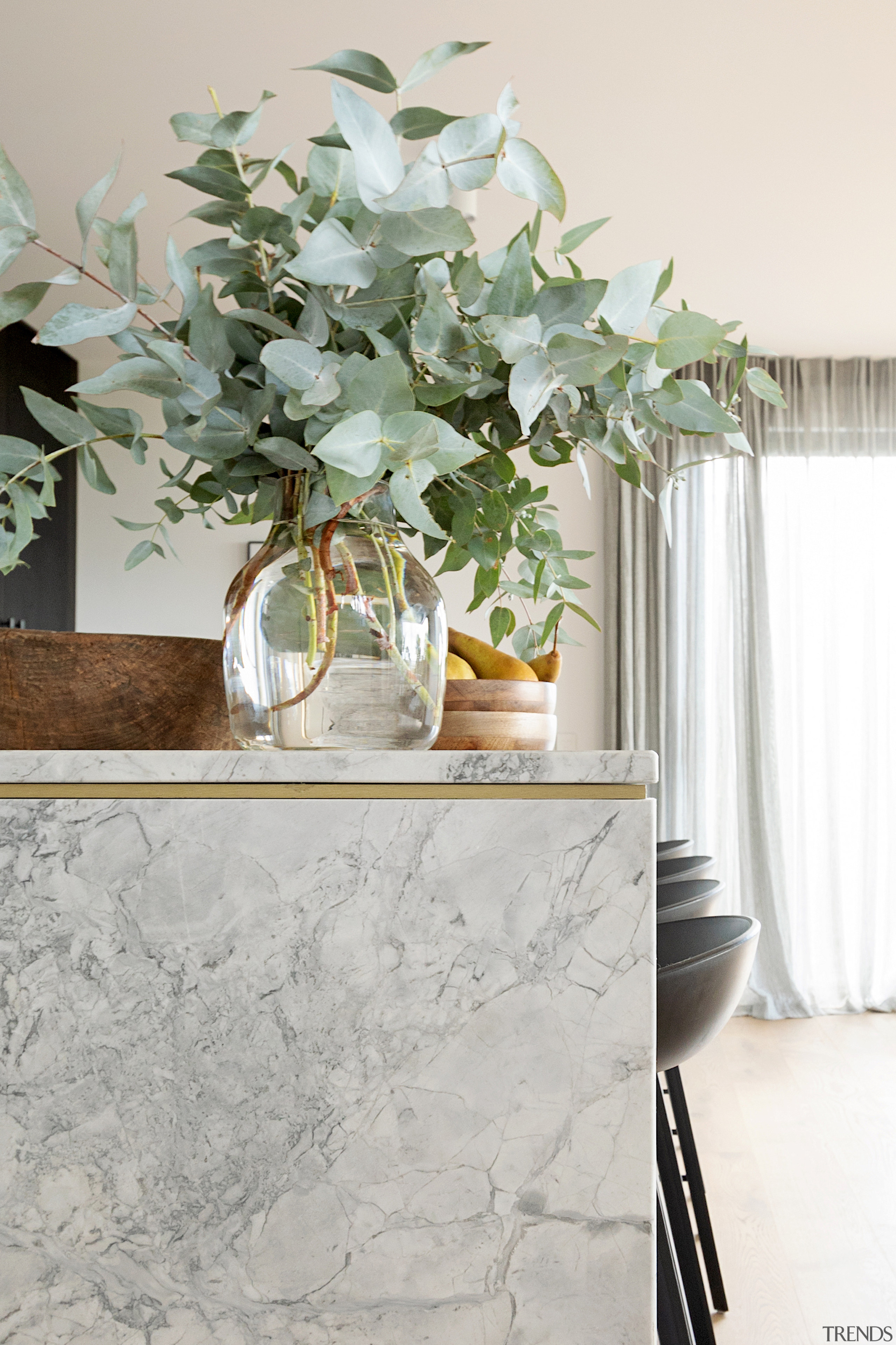 A brass accent line features between the brushed 