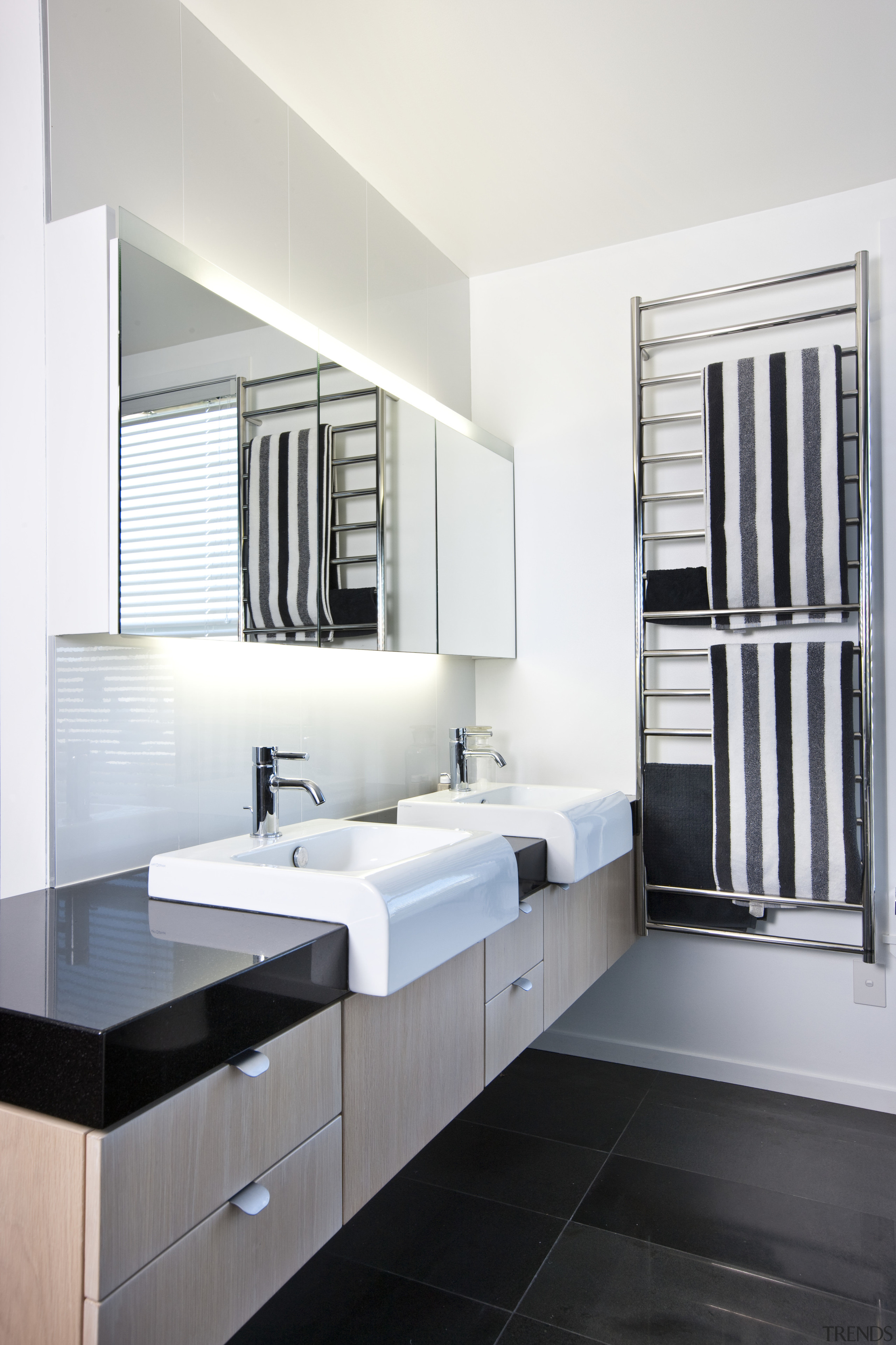 View of the bathroom which features a freestanding bathroom, bathroom accessory, bathroom cabinet, floor, interior design, product design, room, sink, white