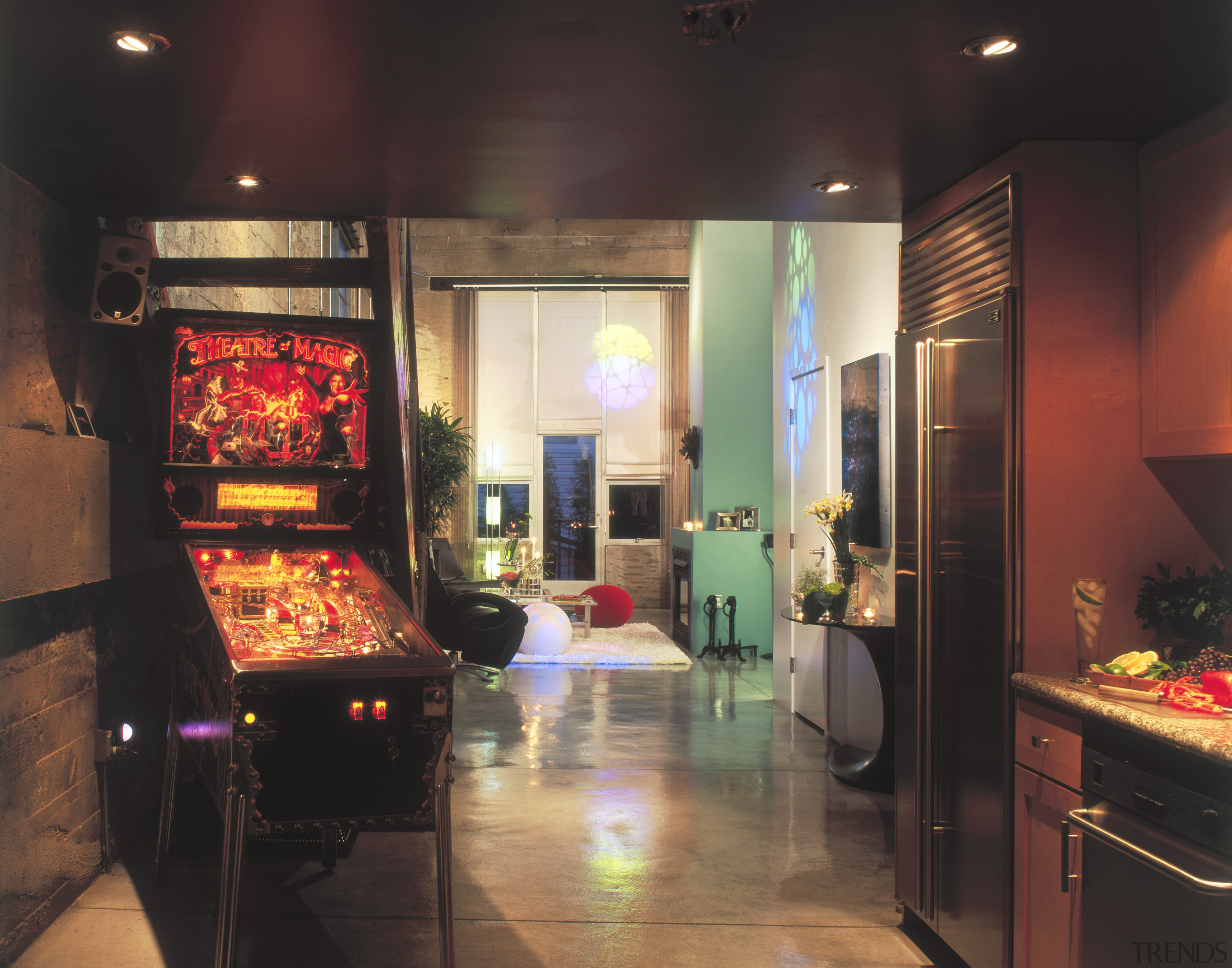 A view of the kitchen area, concrete flooring, electronic device, interior design, recreation room, room, black